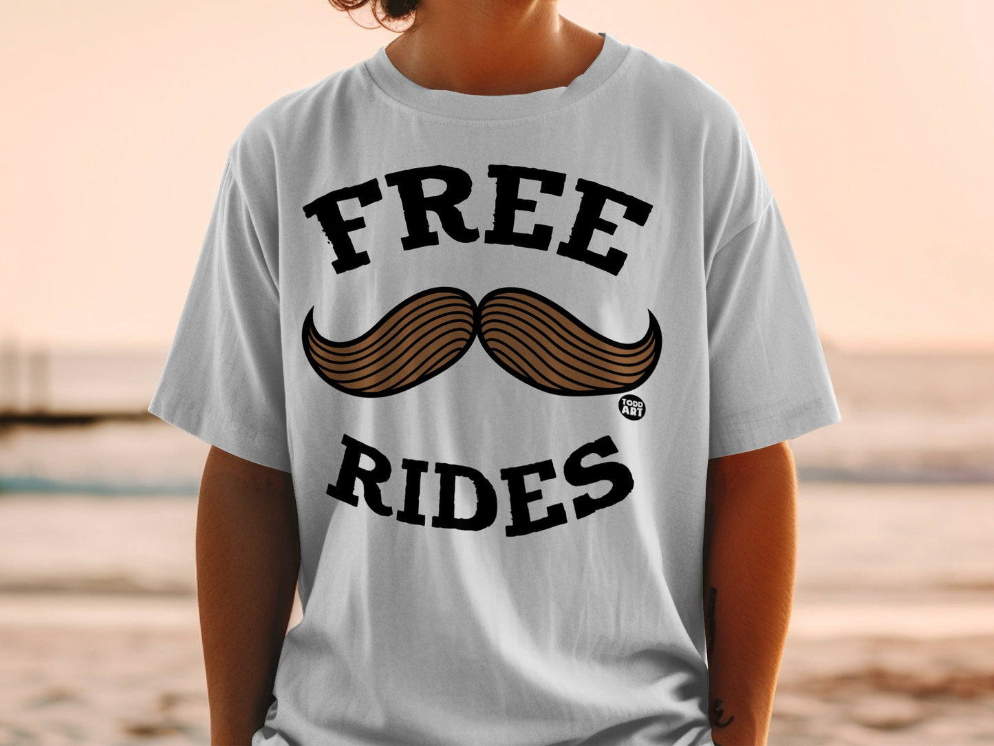 White t-shirt with "FREE RIDES" text and a brown mustache graphic.