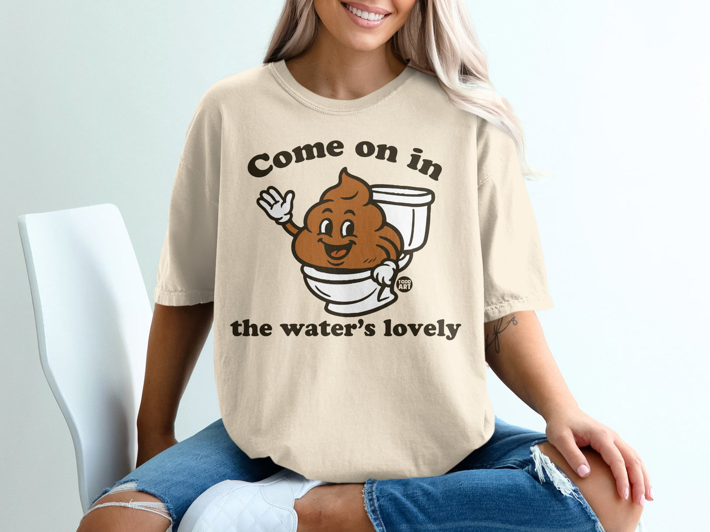 T-shirt with cartoon toilet paper character saying "Come on in the water's lovely."