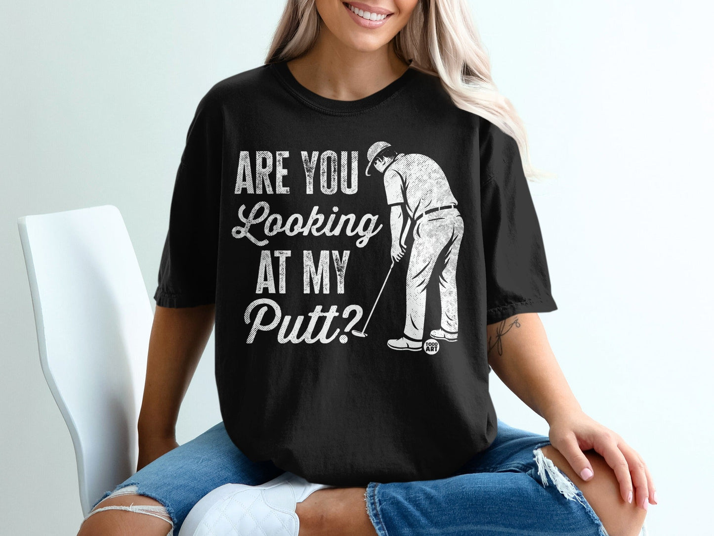 Black t-shirt with "Are You Looking At My Putt?" golf graphic.