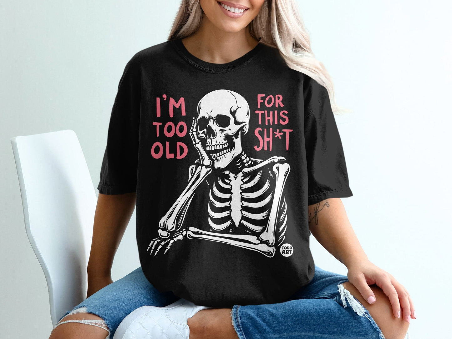 Black t-shirt with a skeleton resting its head on its hand, text reads "I'm too old for this sh*t".