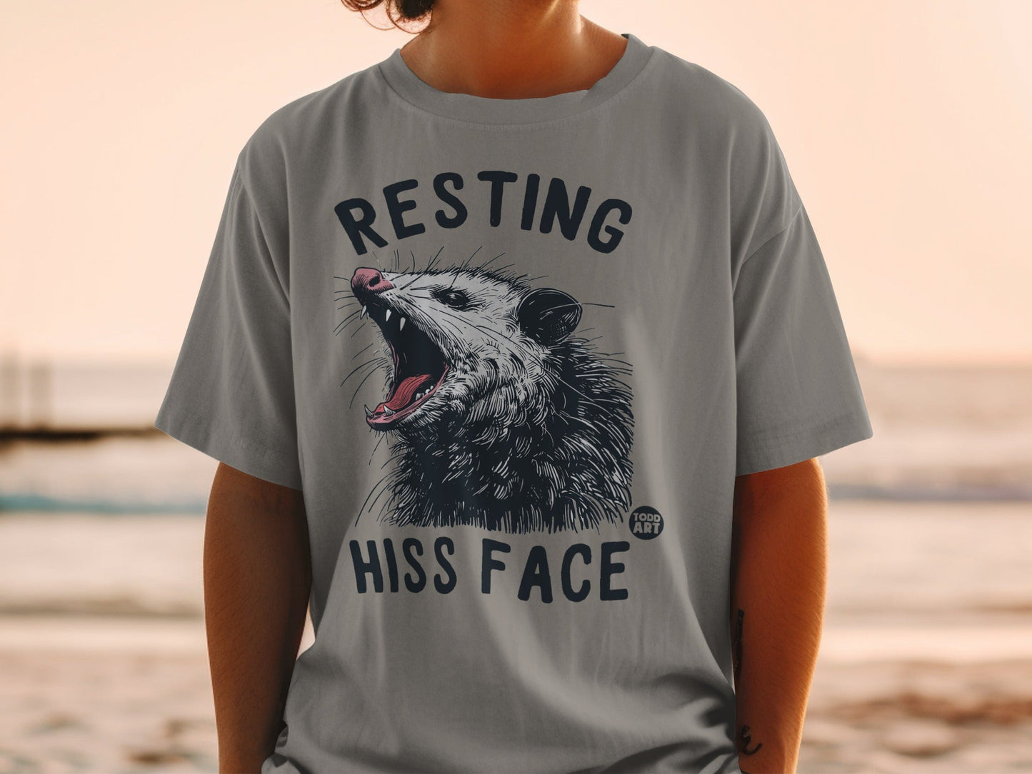 T-shirt with opossum roaring "RESTING HISS FACE" text.