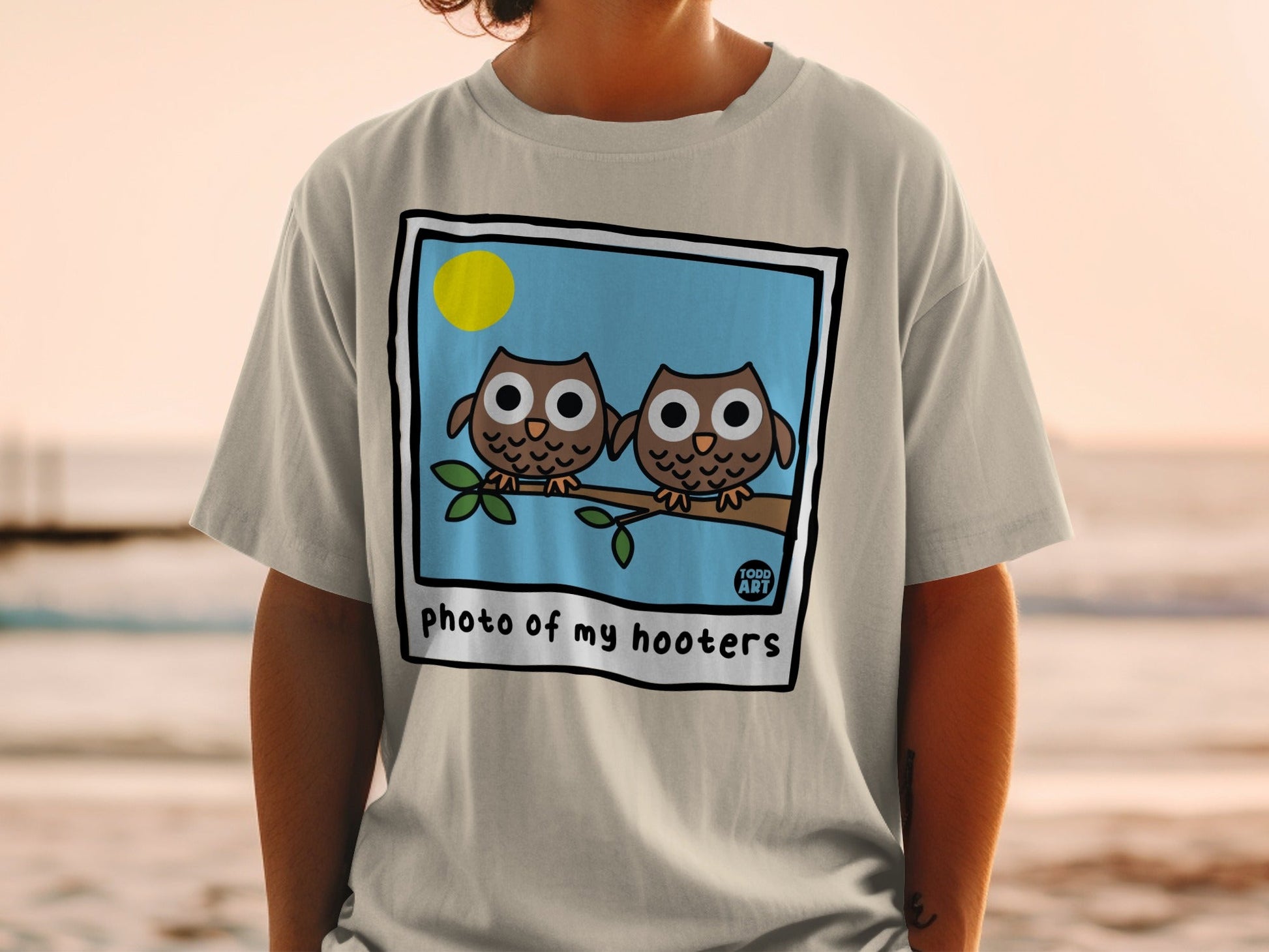 Two cartoon owls on a branch with "photo of my hooters" text.