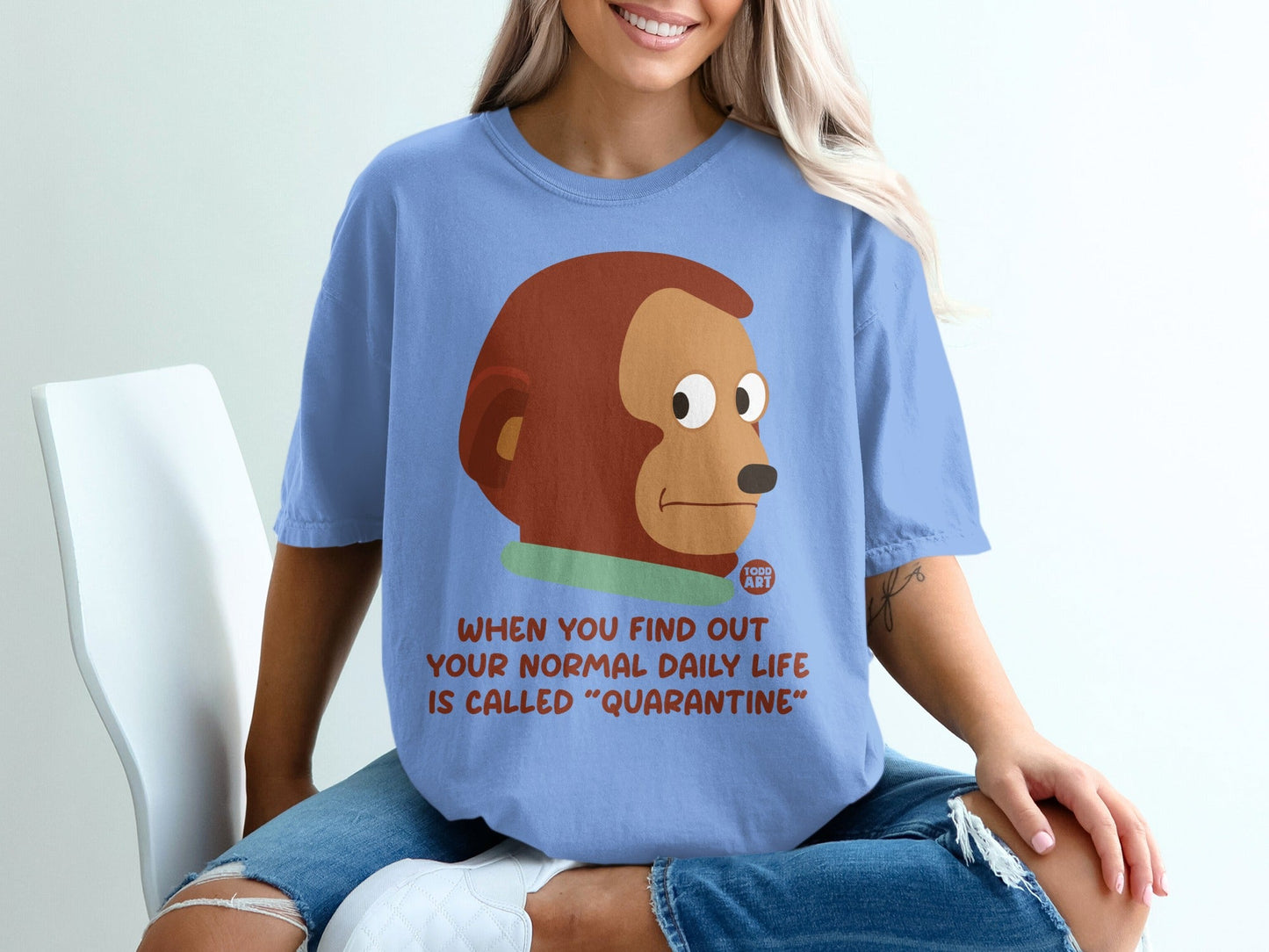 Blue t-shirt with "When you find out your normal daily life is called 'Quarantine'" text and monkey graphic.