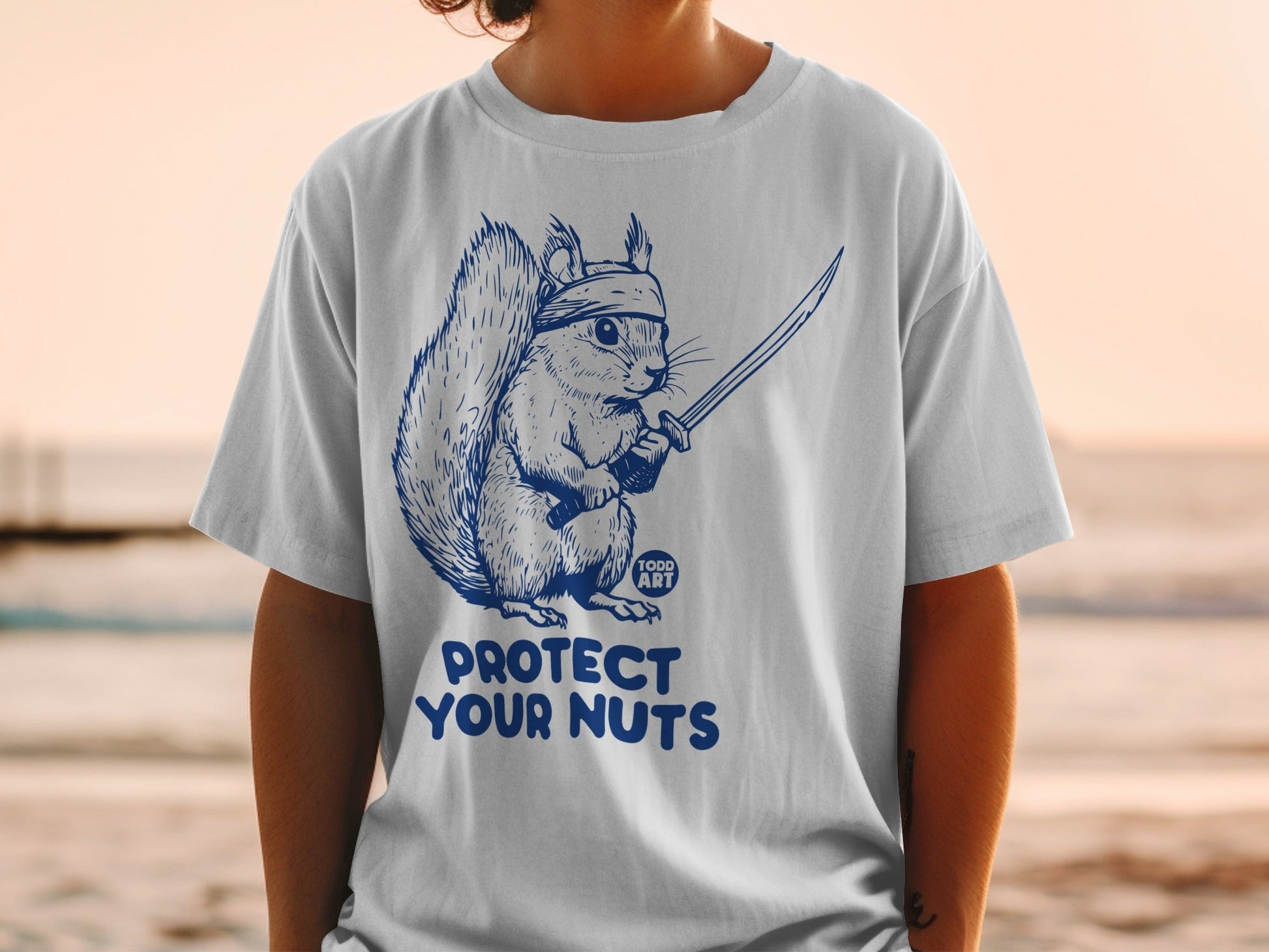 Squirrel in bandana holding a sword with "Protect Your Nuts" text.