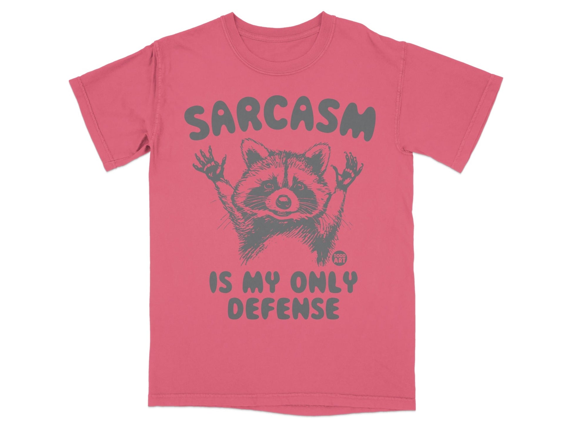 T-shirt with raccoon graphic and "SARCASTIC IS MY ONLY DEFENSE" text.