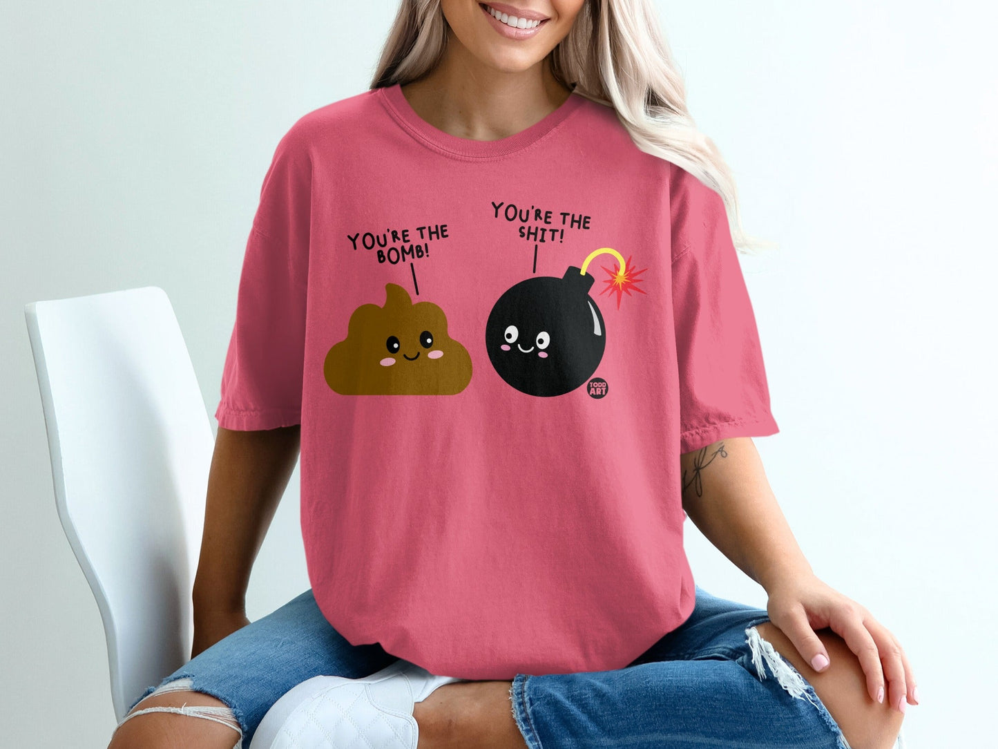 Pink t-shirt with cartoon poop and bomb characters saying "You're the bomb!".