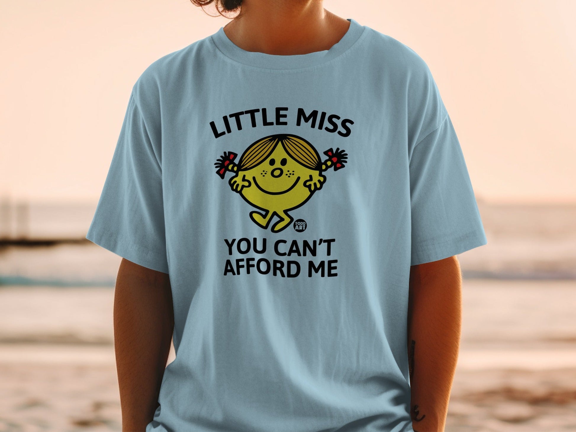 Light blue t-shirt with "Little Miss You Can't Afford Me" graphic.