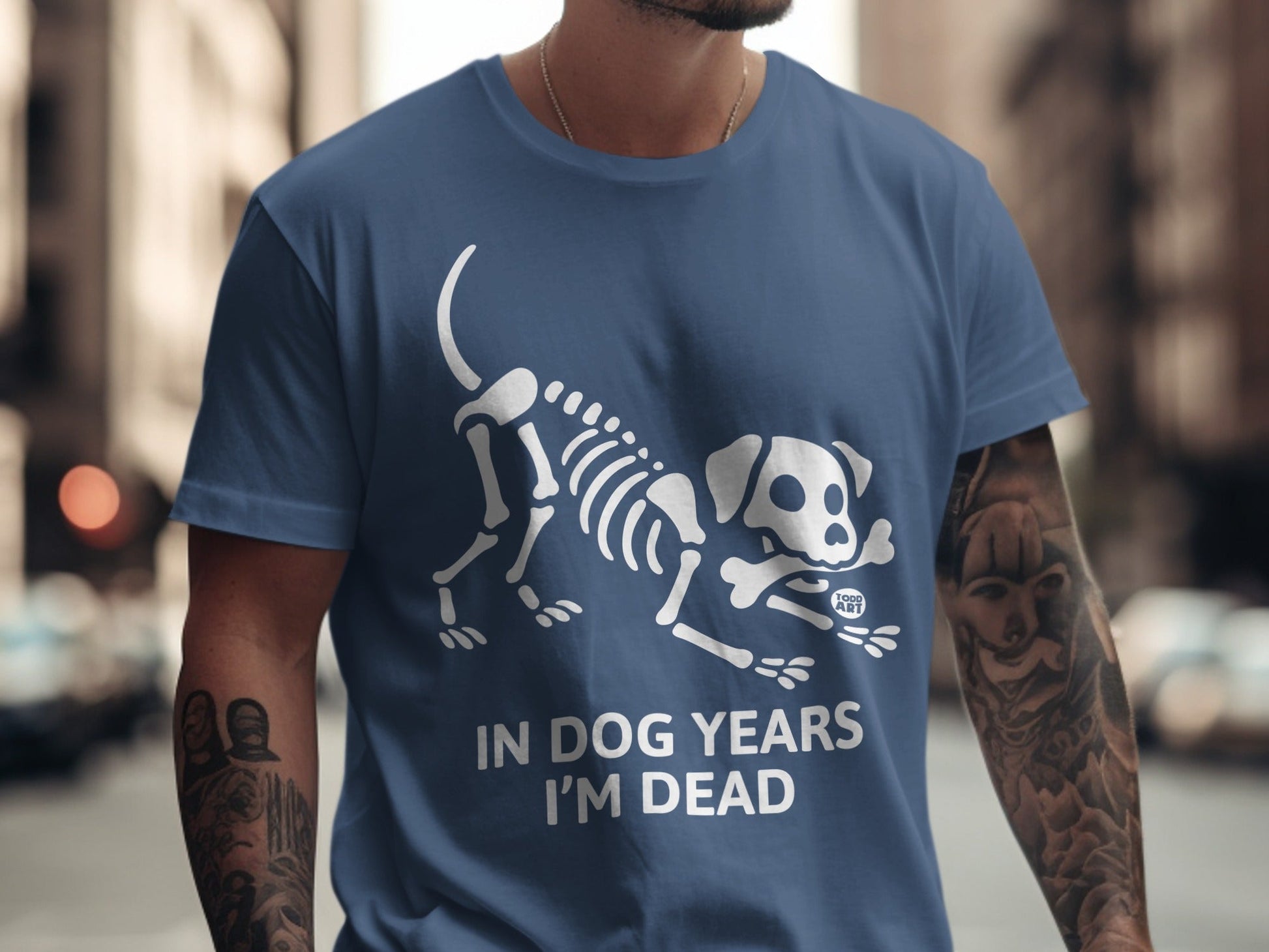 Blue t-shirt with a white skeleton dog and "IN DOG YEARS I'M DEAD" text.