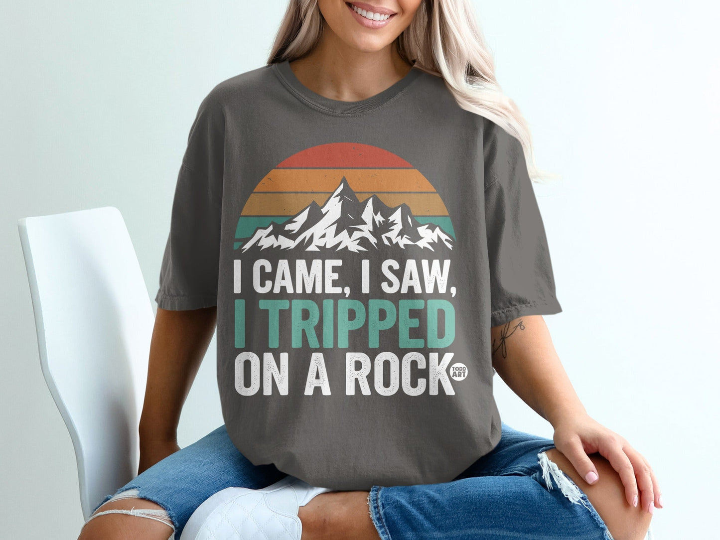 Dark gray t-shirt with mountain graphic and "I came, I saw, I tripped on a rock" text.
