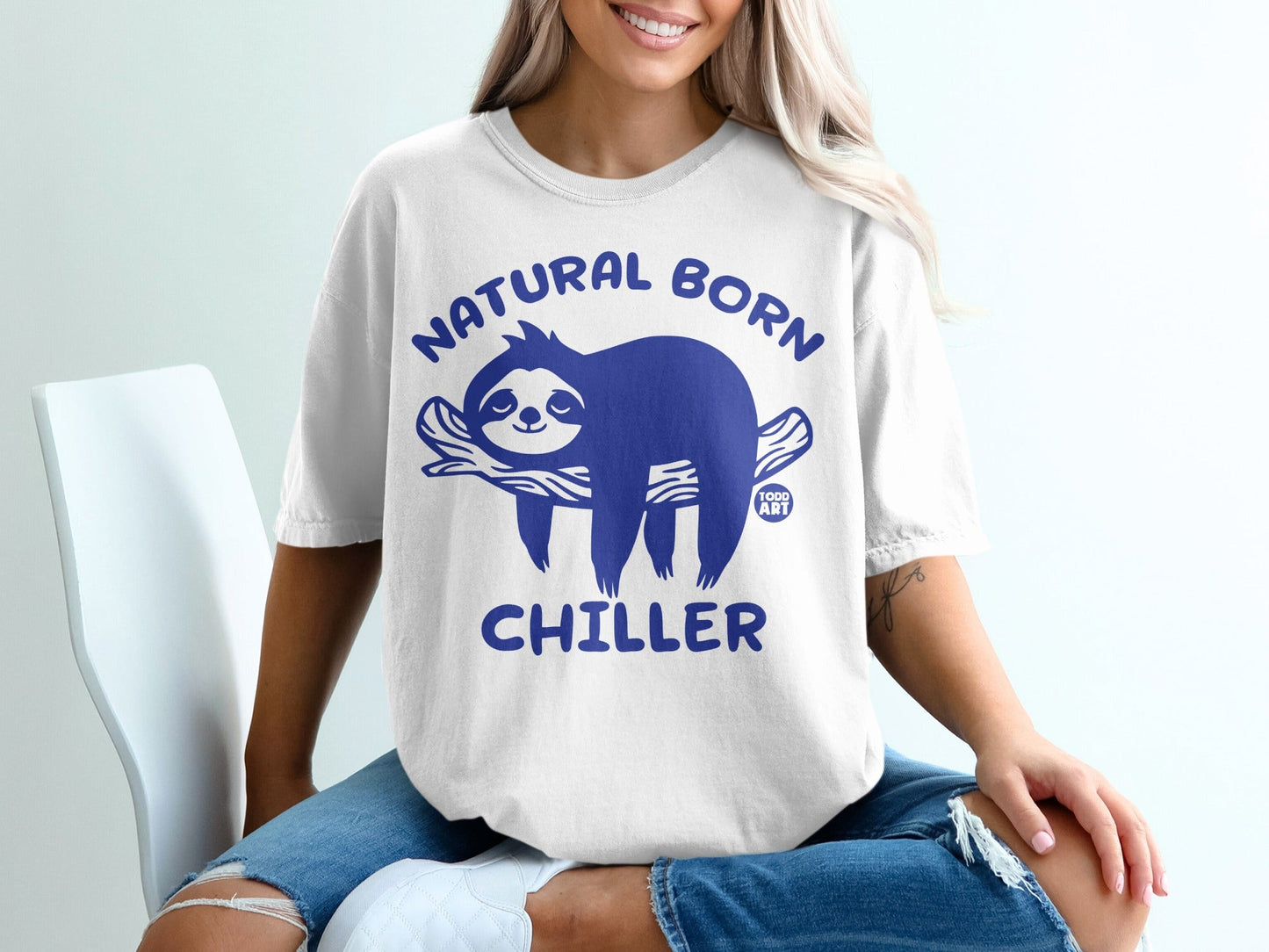 White t-shirt with blue sloth graphic and text "NATURAL BORN CHILLER".