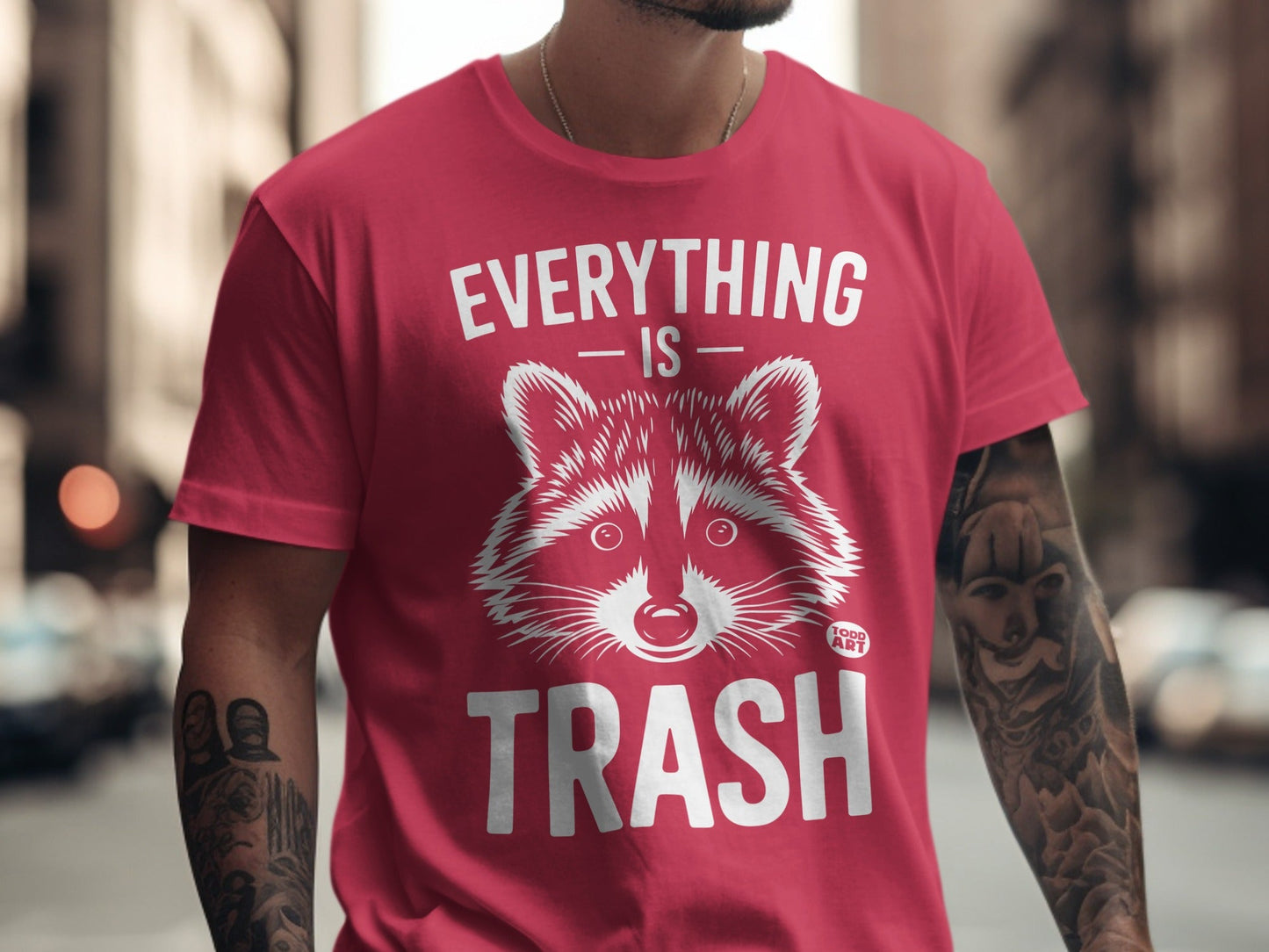 Red t-shirt with raccoon graphic and text "EVERYTHING IS TRASH".