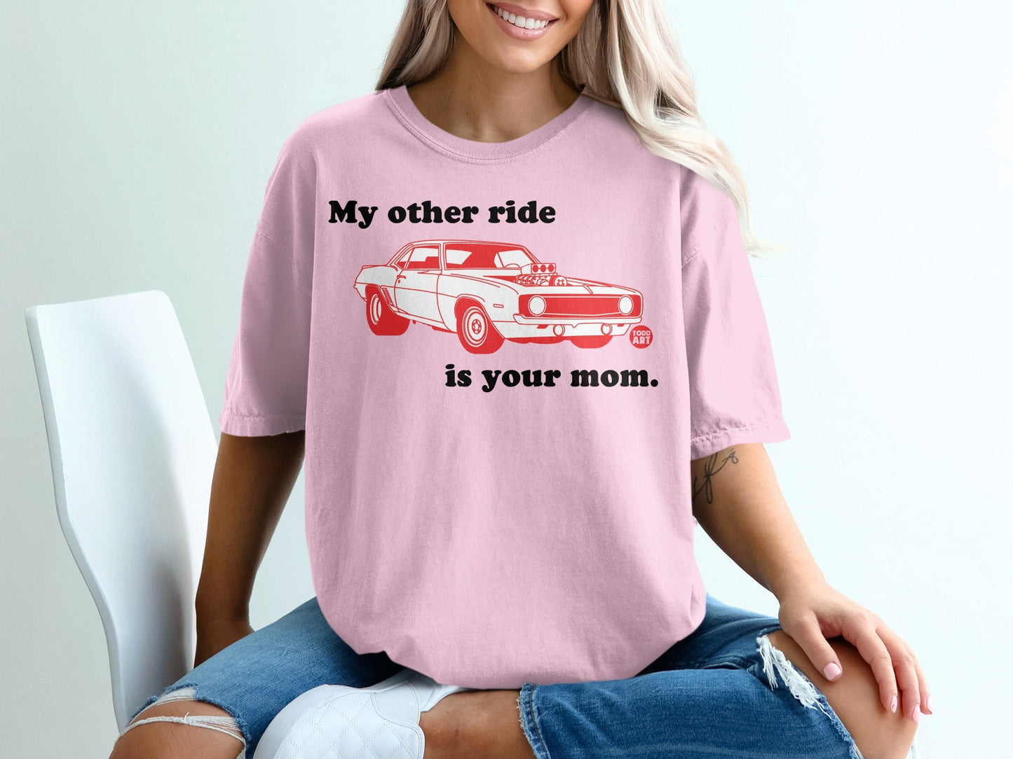 Pink t-shirt with red text "My other ride is your mom" and a vintage car graphic.