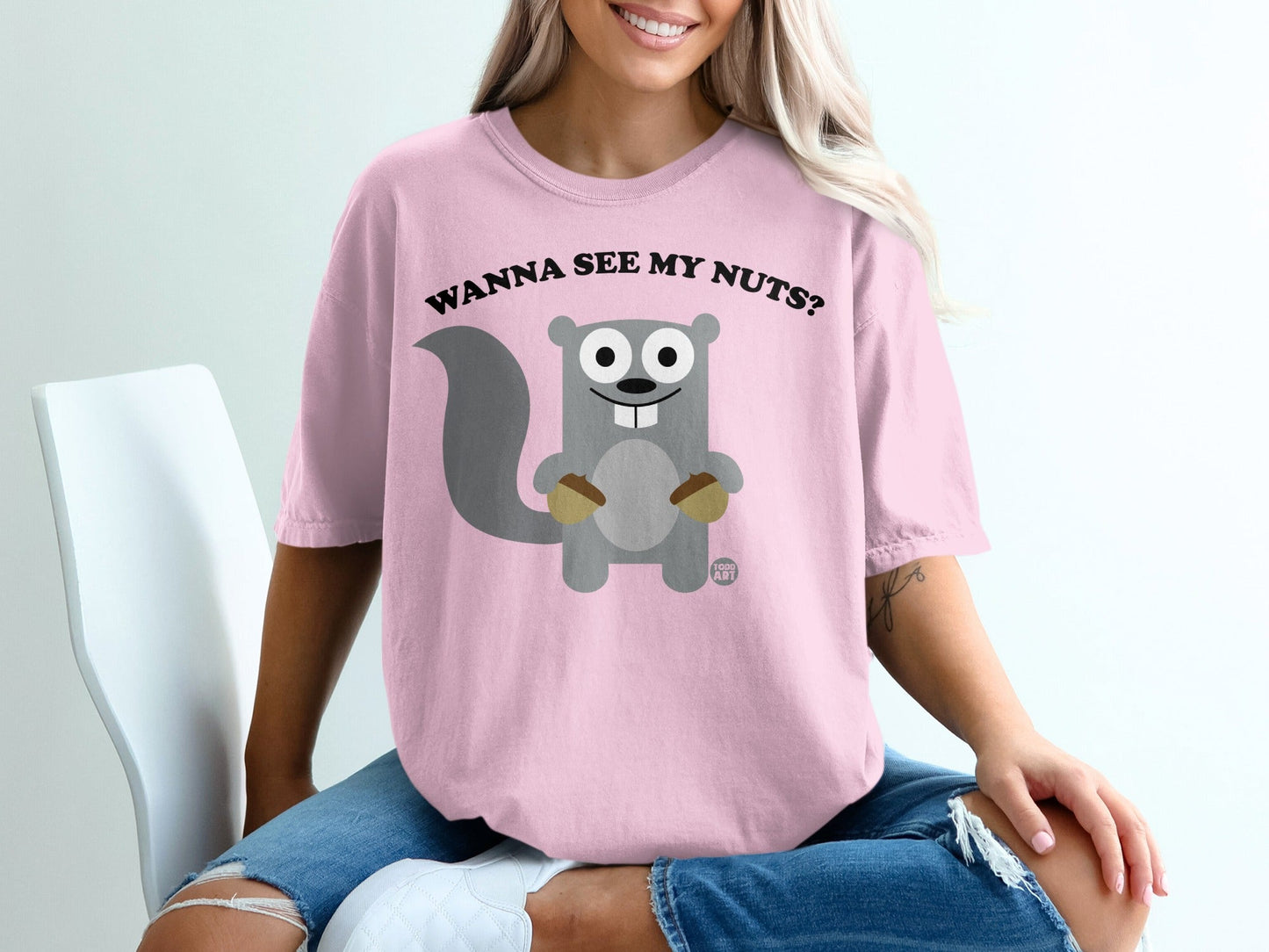 Pink t-shirt with cartoon squirrel asking "Wanna see my nuts?"