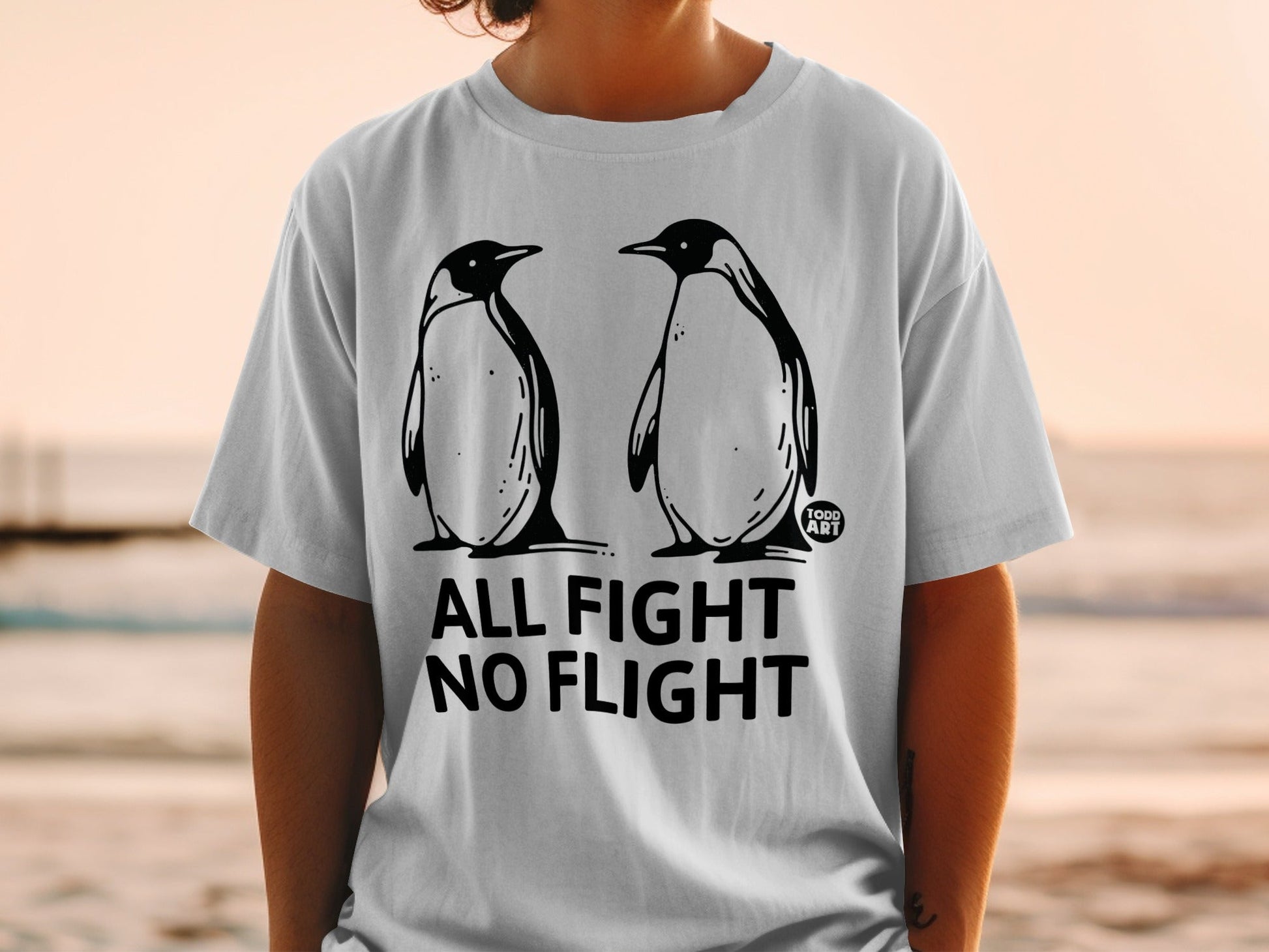 T-shirt with two penguins and text "ALL FIGHT NO FLIGHT".
