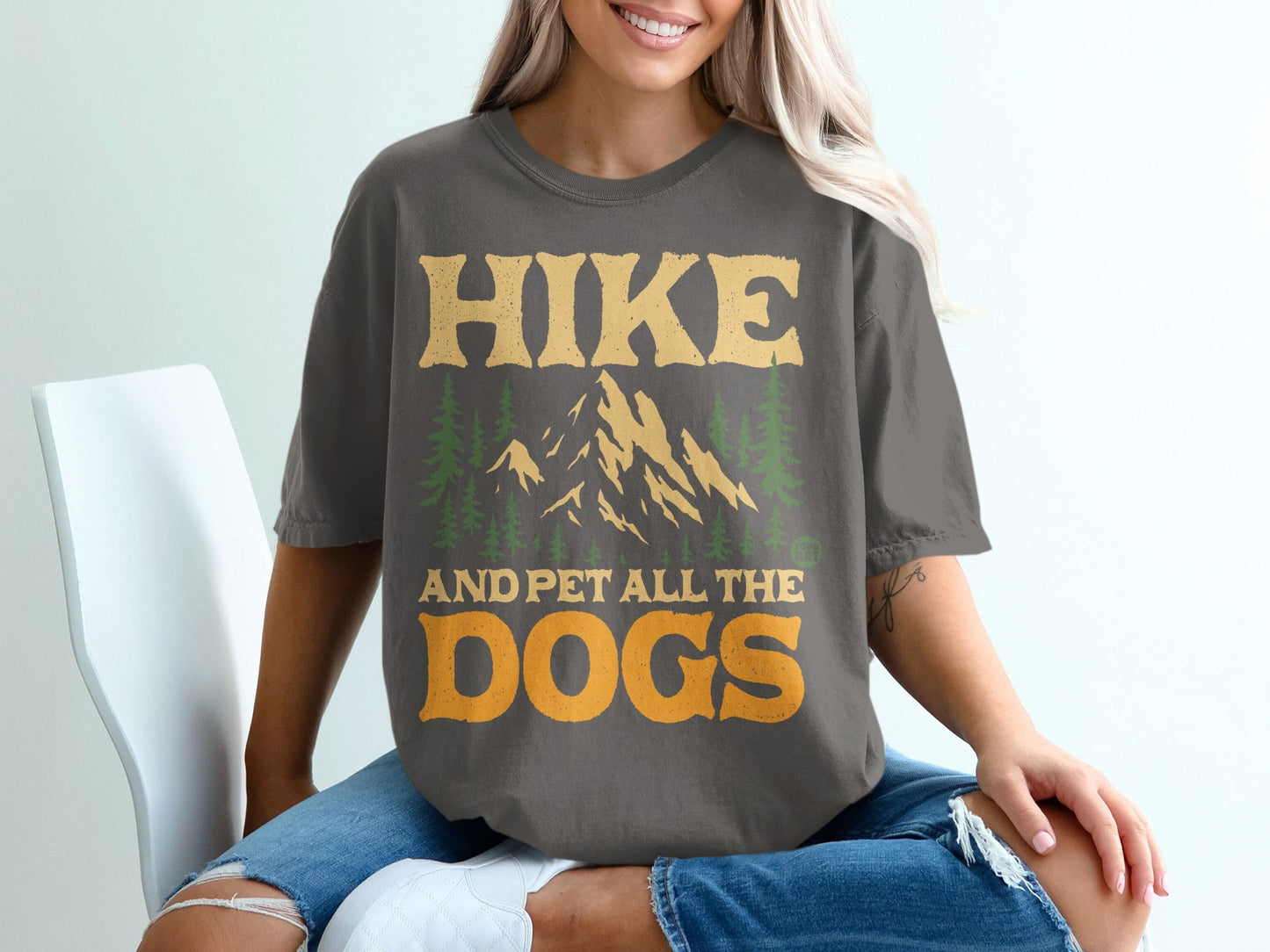 Gray t-shirt with "Hike and Pet All the Dogs" text and mountain graphic.