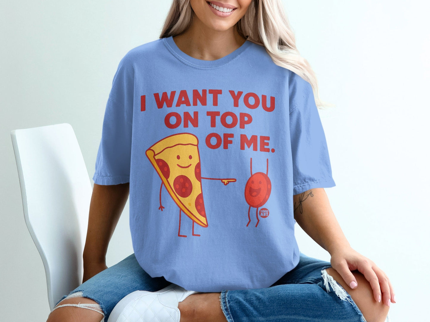 T-shirt with pepperoni pizza slice saying "I want you on top of me".