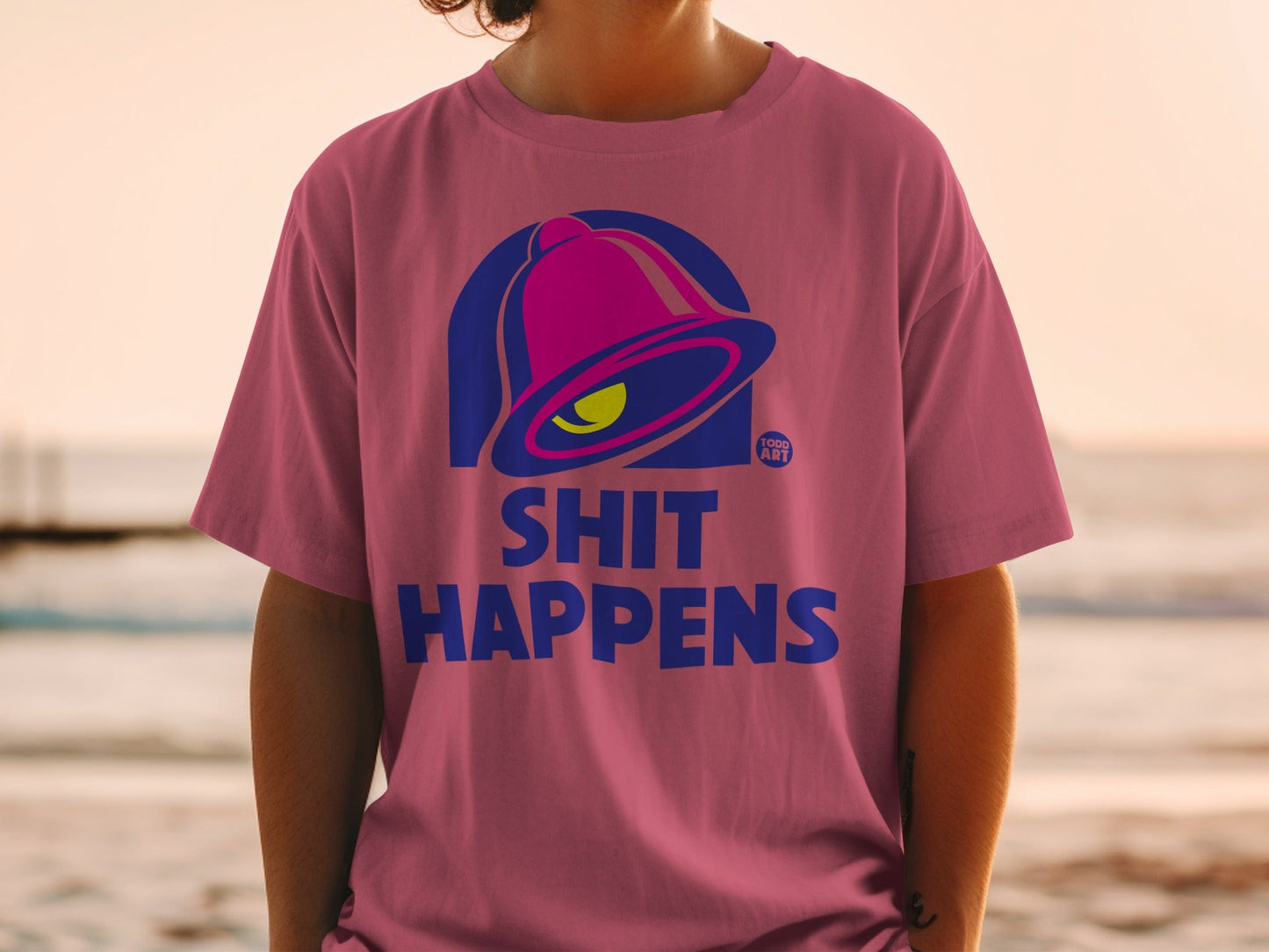 Pink t-shirt with Taco Bell logo and "Shit Happens" text.