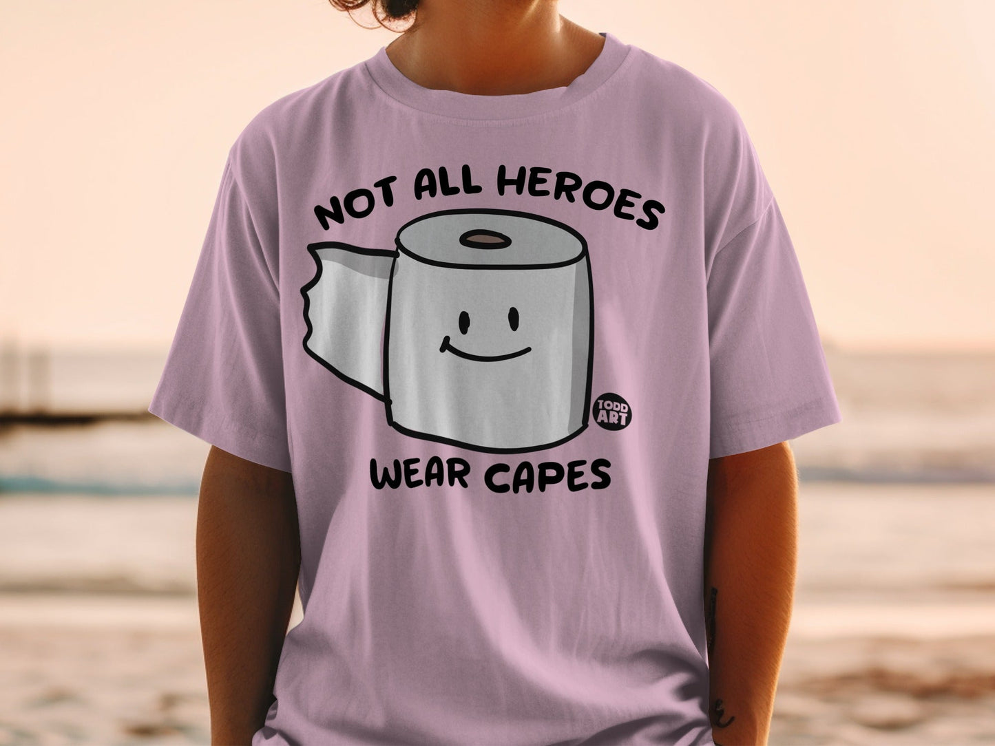 Pink t-shirt with toilet paper saying "Not All Heroes Wear Capes."