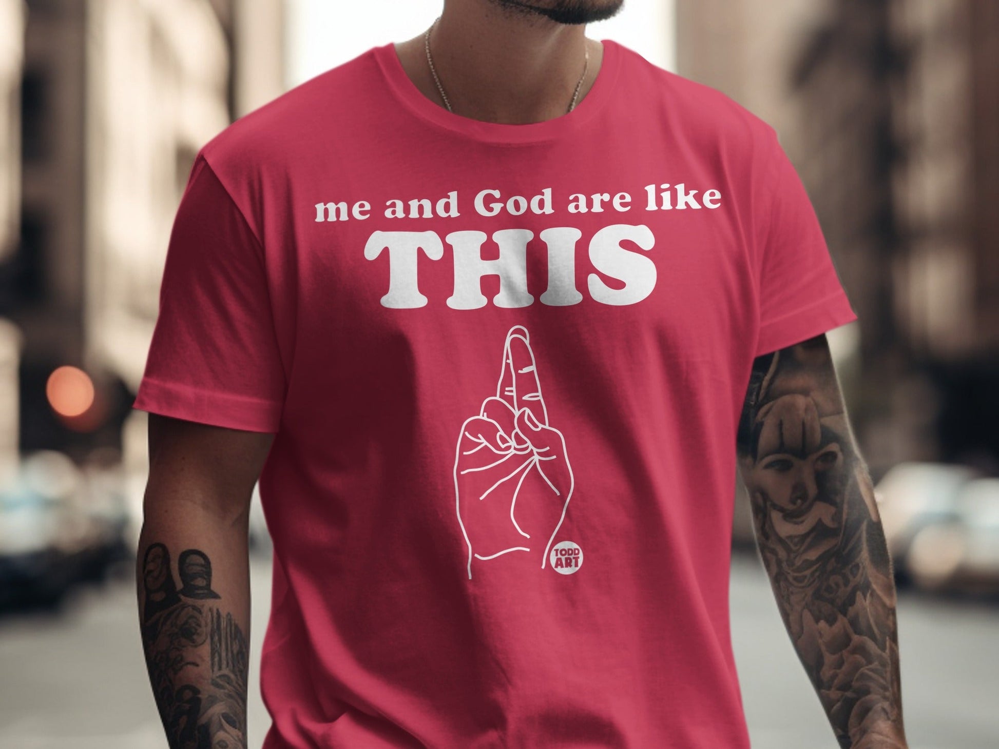 Pink t-shirt with white text "me and God are like THIS" and a hand gesture.