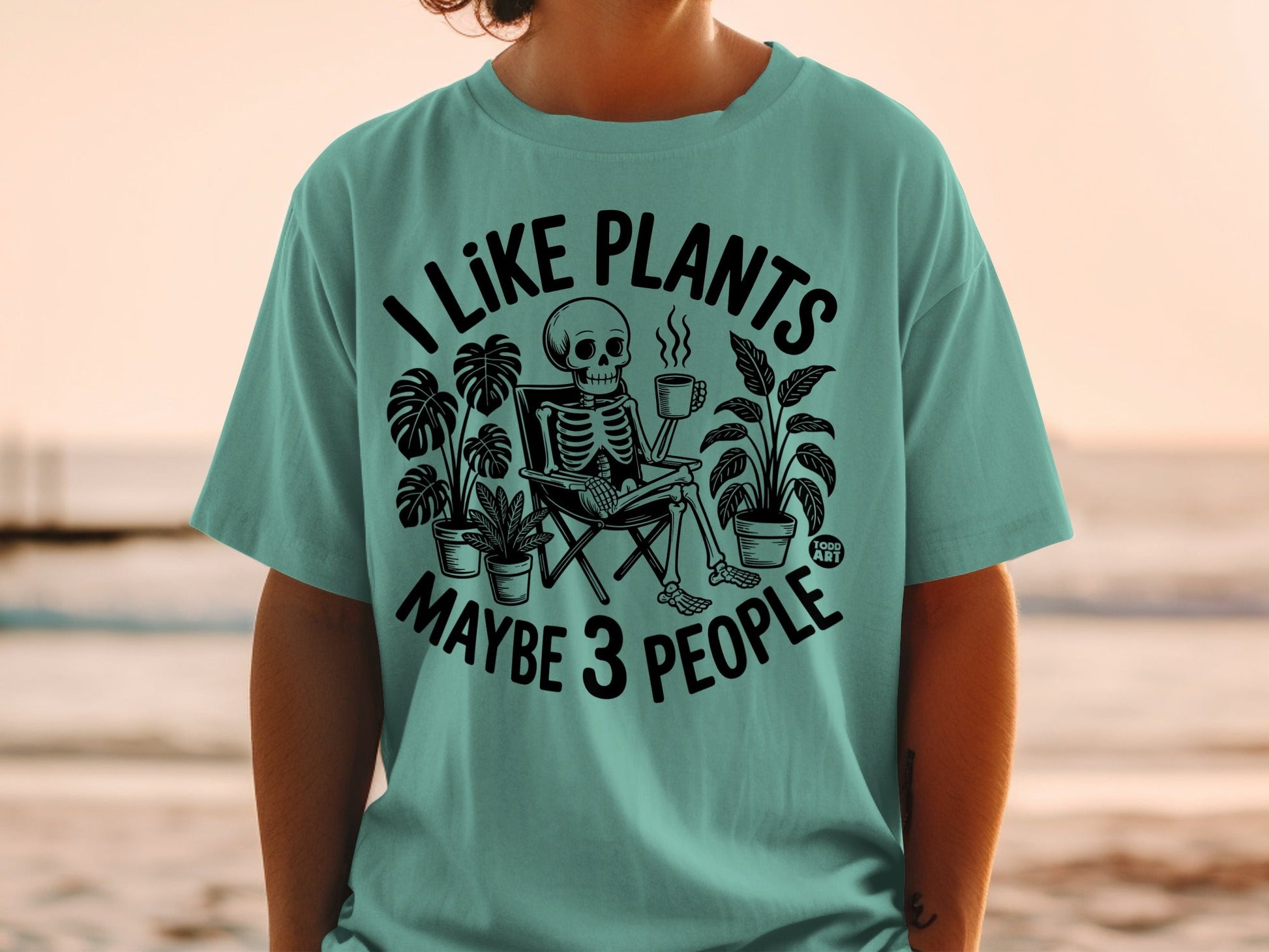 Skeleton sitting in chair, holding coffee, surrounded by plants, text says "I LIKE PLANTS MAYBE 3 PEOPLE".