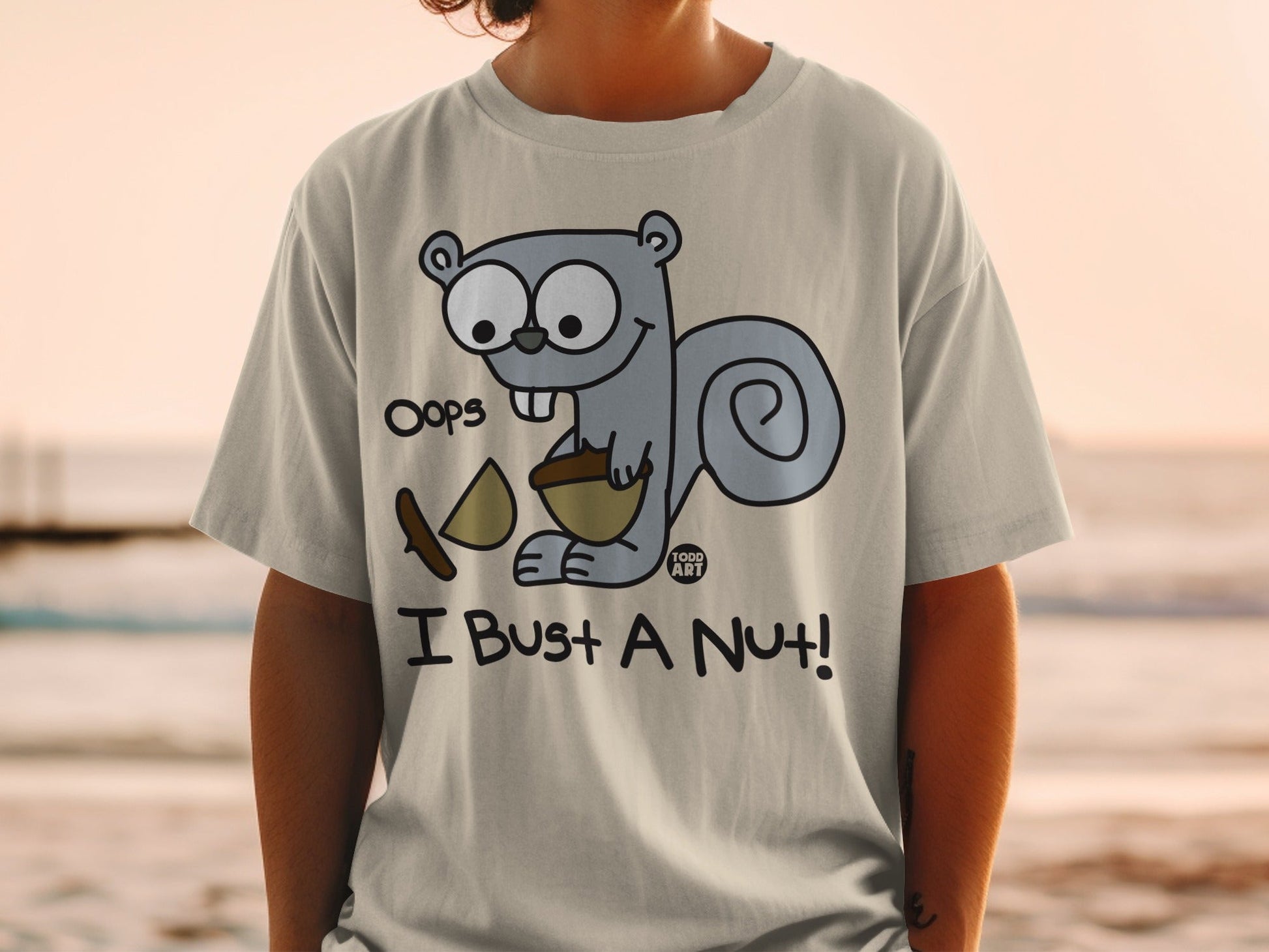 T-shirt with cartoon squirrel saying "Oops I Bust a Nut!".