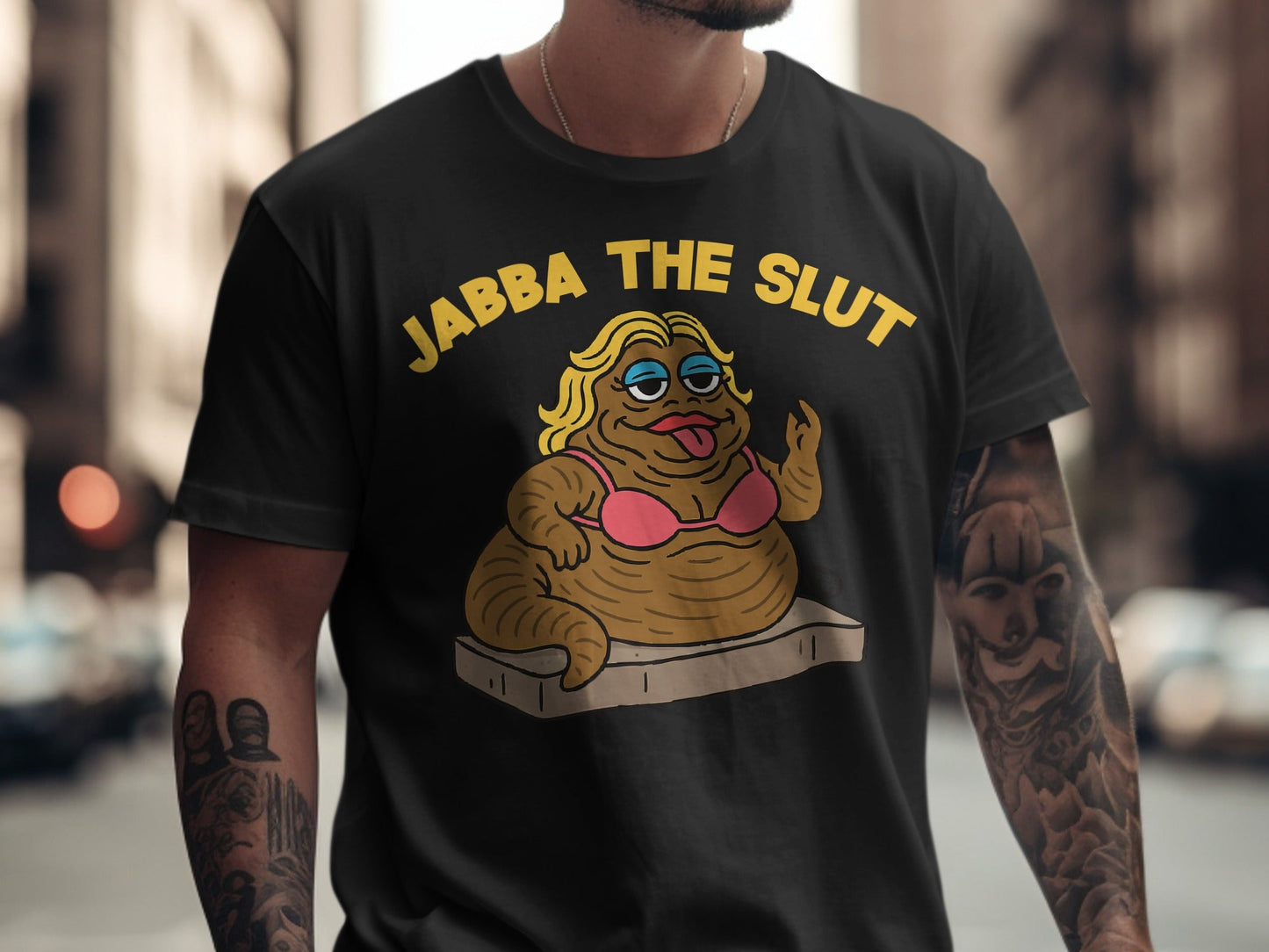 Black t-shirt with cartoon of Jabba the Hutt in a pink bikini saying "JABBA THE SLUT".