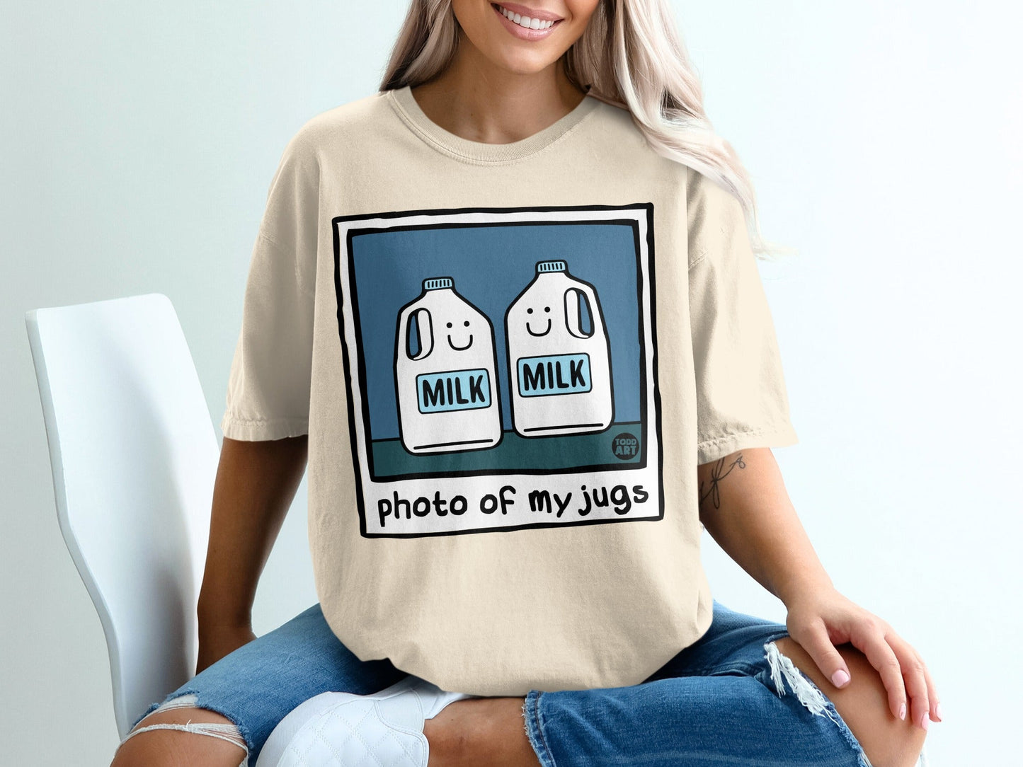 T-shirt featuring cartoon milk jugs with smiling faces and the text "photo of my jugs."