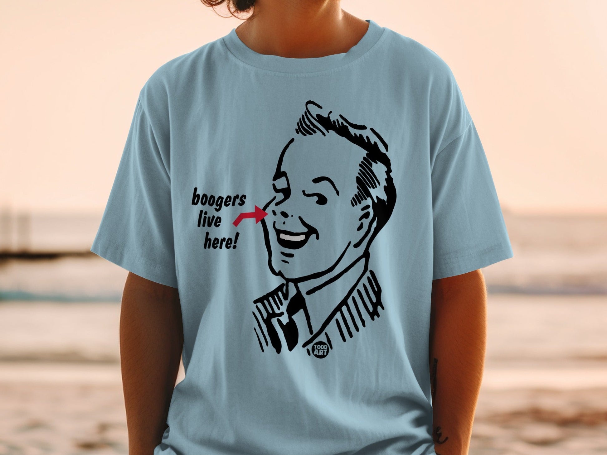 Light blue t-shirt featuring a vintage comic illustration of a man with "boogers live here!" text.