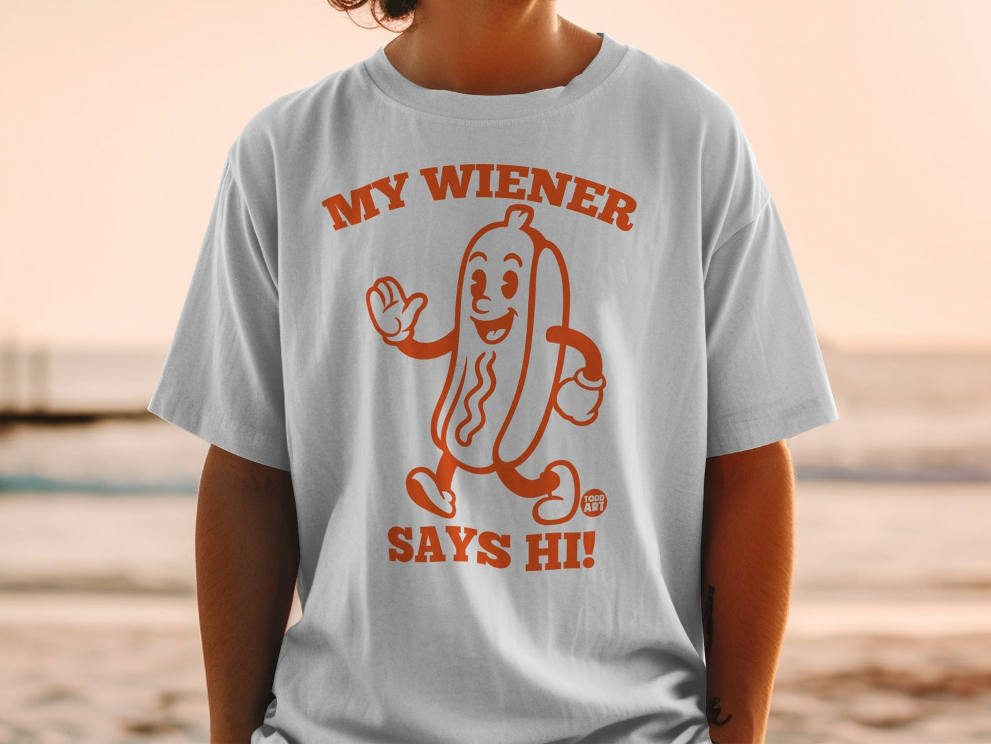 T-shirt with cartoon hot dog saying "MY WIENER SAYS HI!".