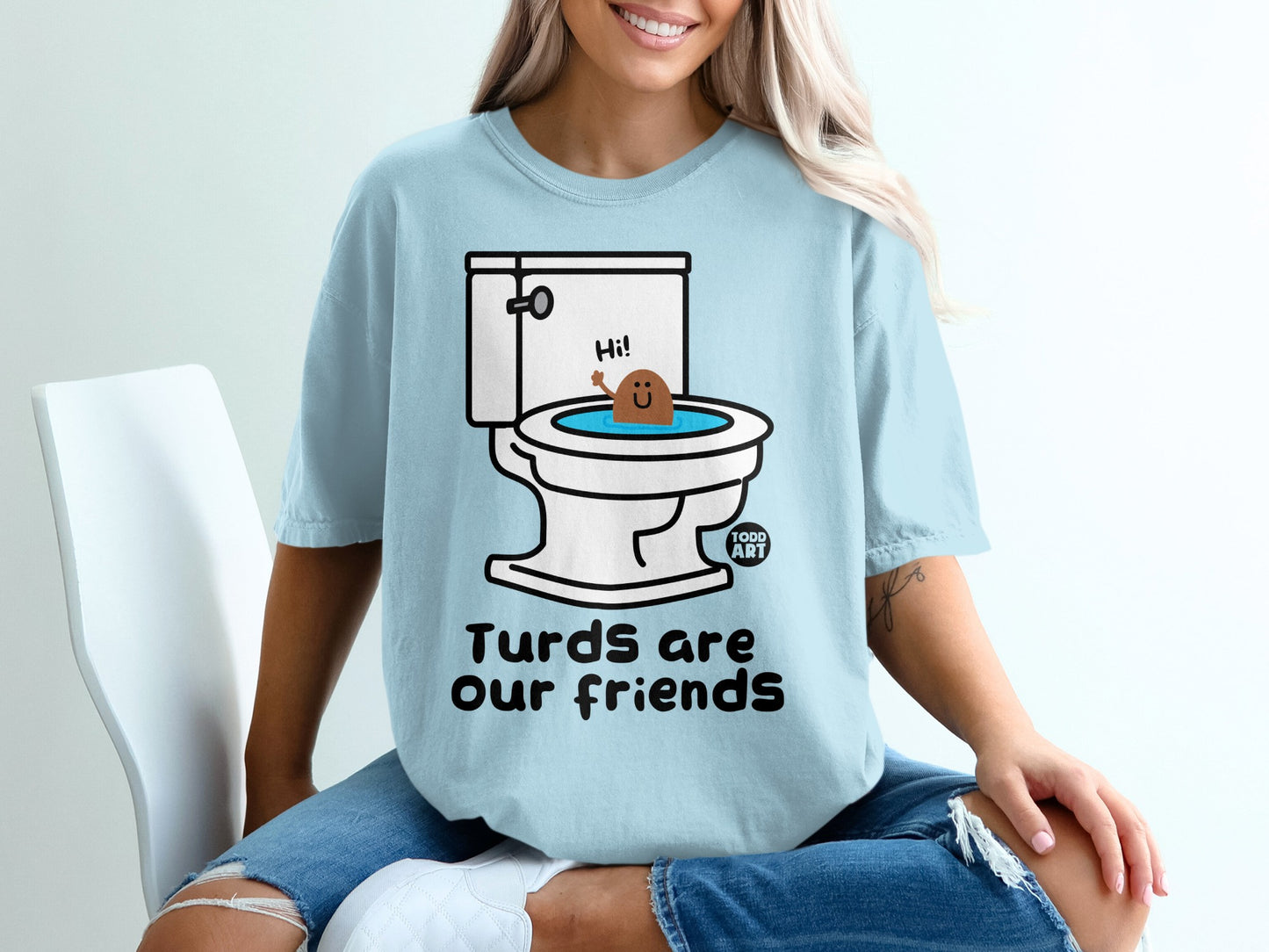 Light blue t-shirt with cartoon toilet and smiling poop, text "Turds are our friends".