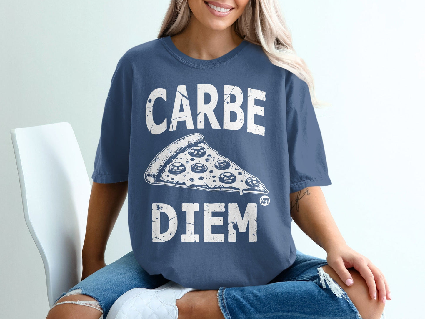 Woman in blue t-shirt with "CARPE DIEM" and pizza graphic.