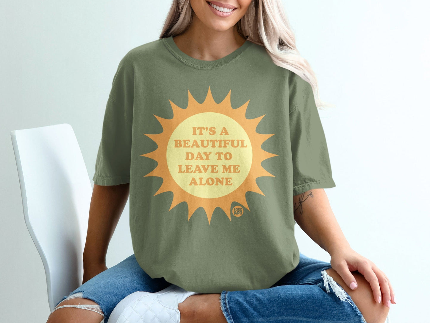Green t-shirt with a sun graphic and text: "It's a beautiful day to leave me alone".