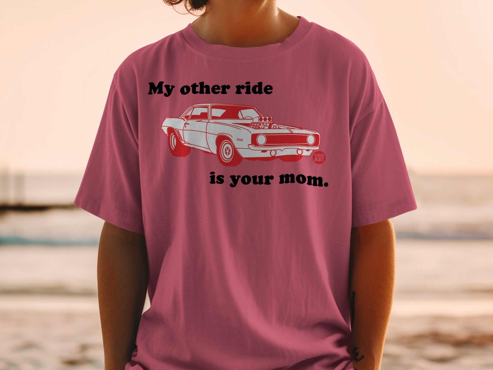 T-shirt with illustration of a red classic car and text "My other ride is your mom".