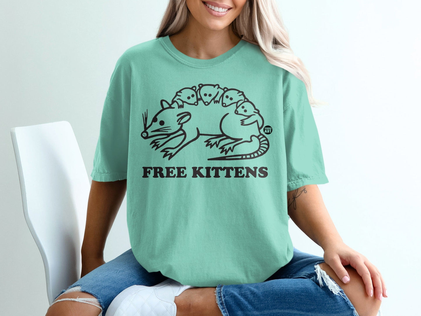 Opossum with kittens on its back, text reads "FREE KITTENS".