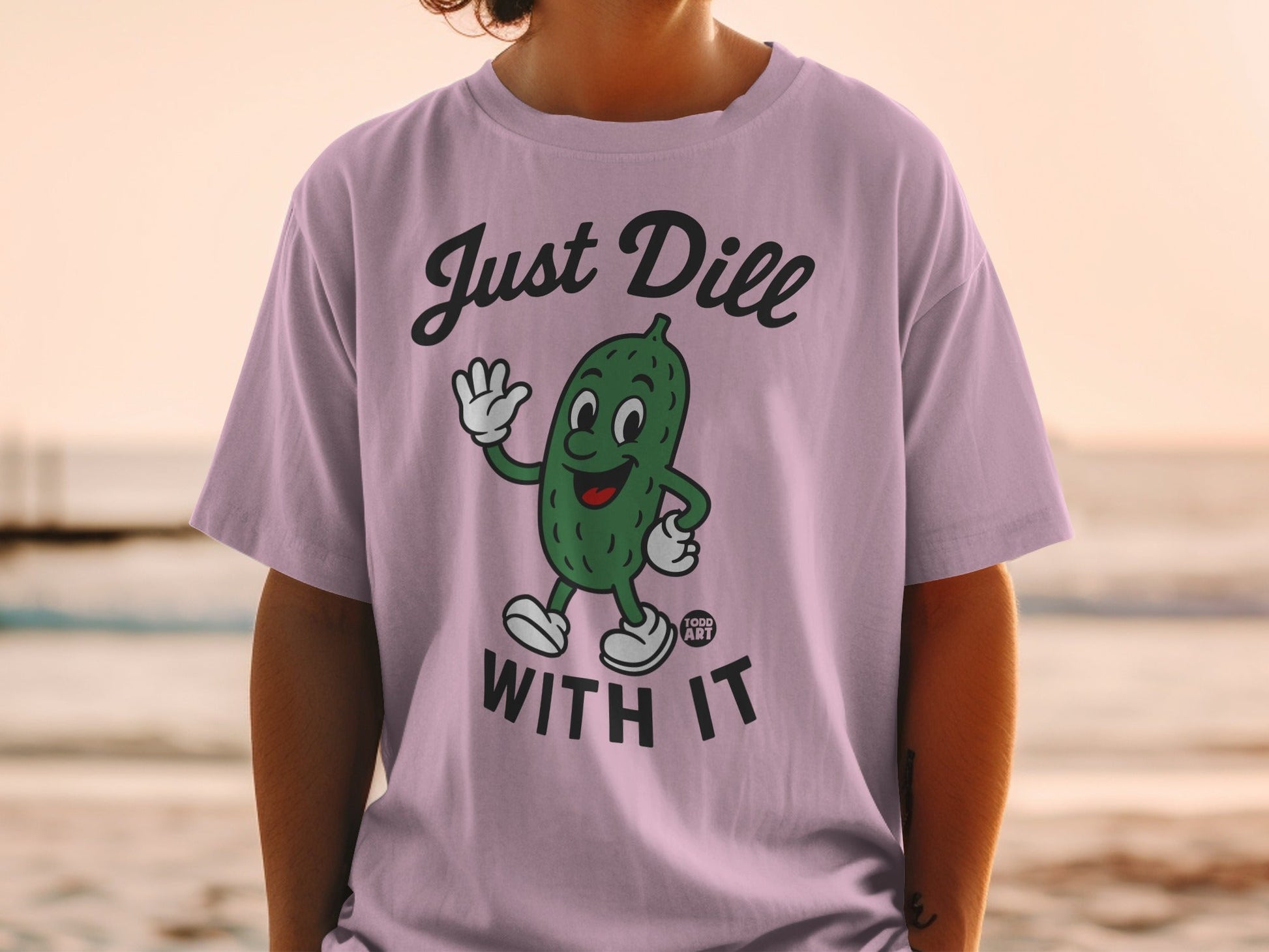 T-shirt with cartoon pickle saying "Just Dill With It".