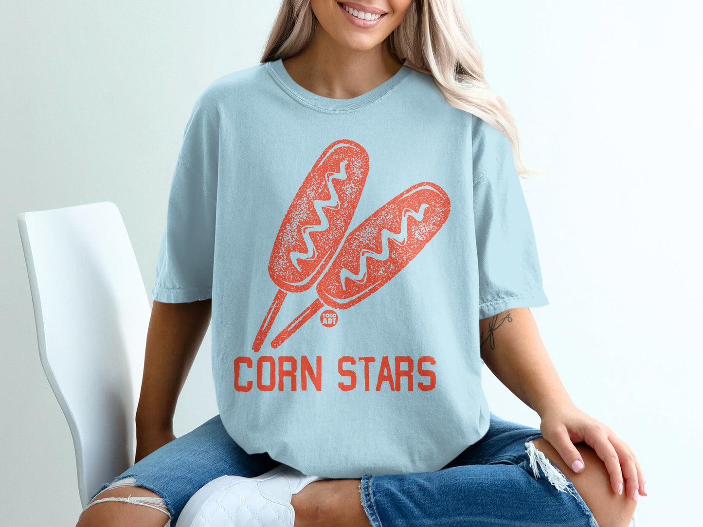 Light blue t-shirt with corn dogs and "Corn Stars" text.