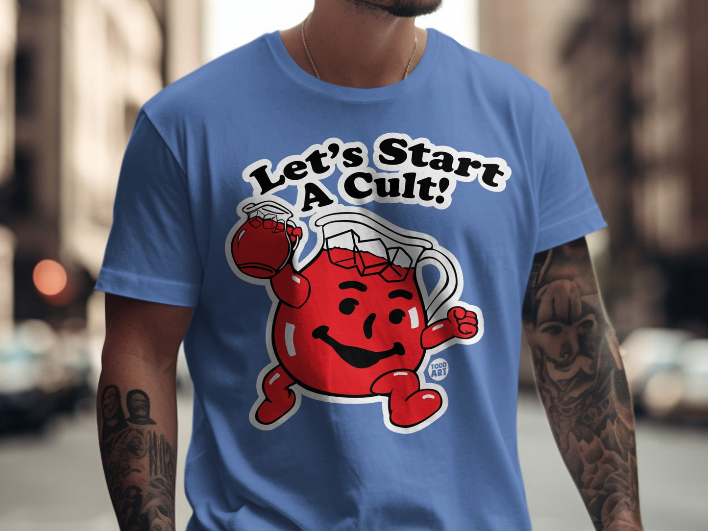 Kool-Aid Man character on blue t-shirt with text "Let's Start A Cult!".