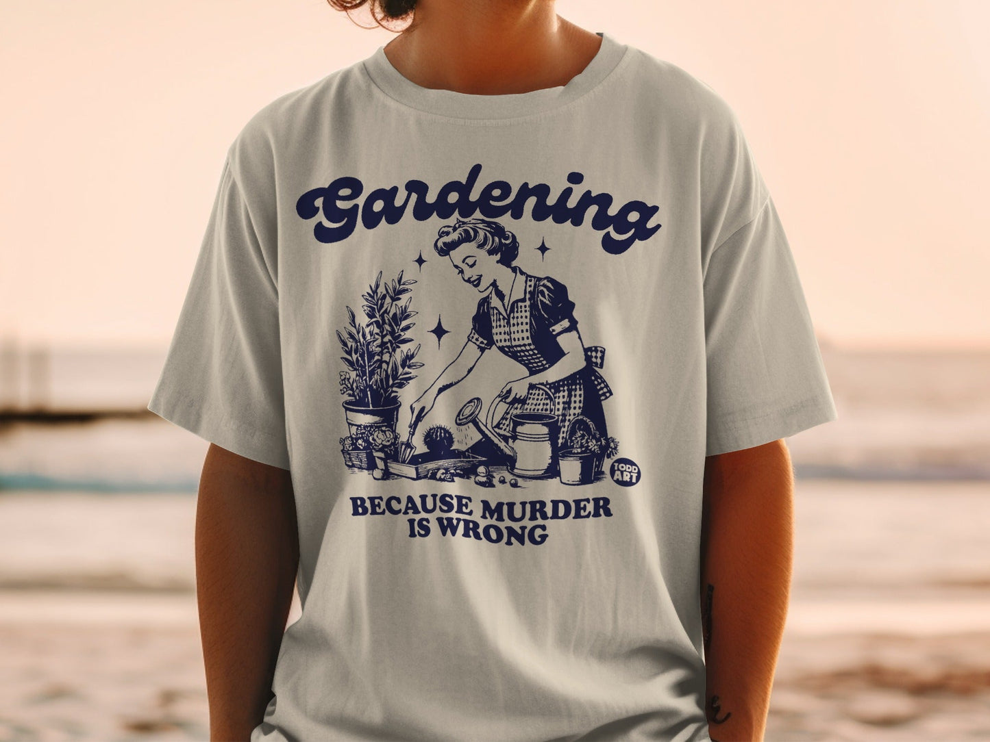T-shirt graphic of a retro woman watering plants, text reads "Gardening is Wrong".