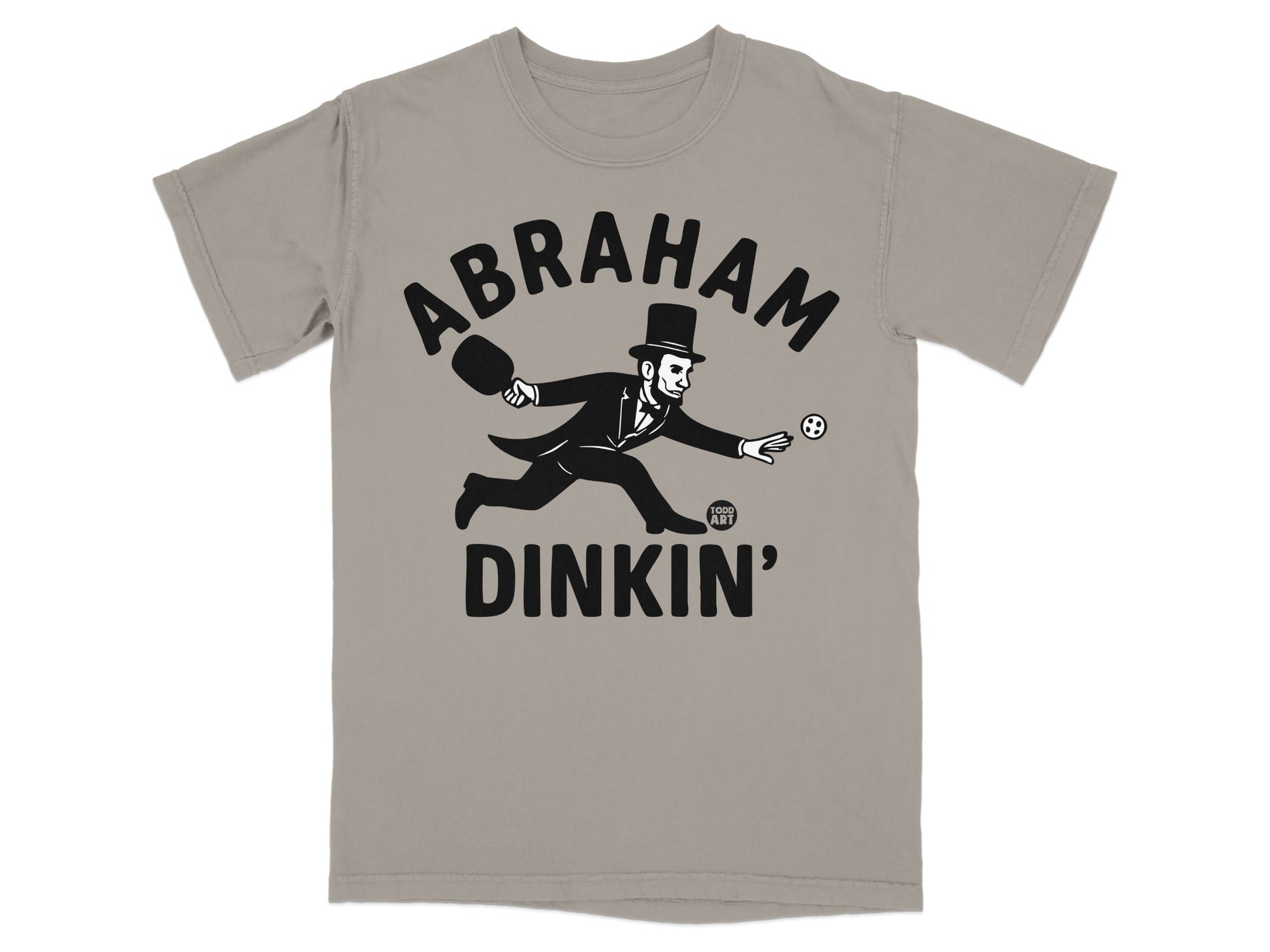 Abraham Lincoln in a top hat playing pickleball on a grey t-shirt.