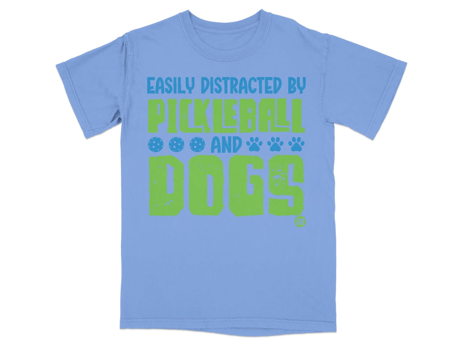 Light blue t-shirt with green text and pickleball/paw print graphics.