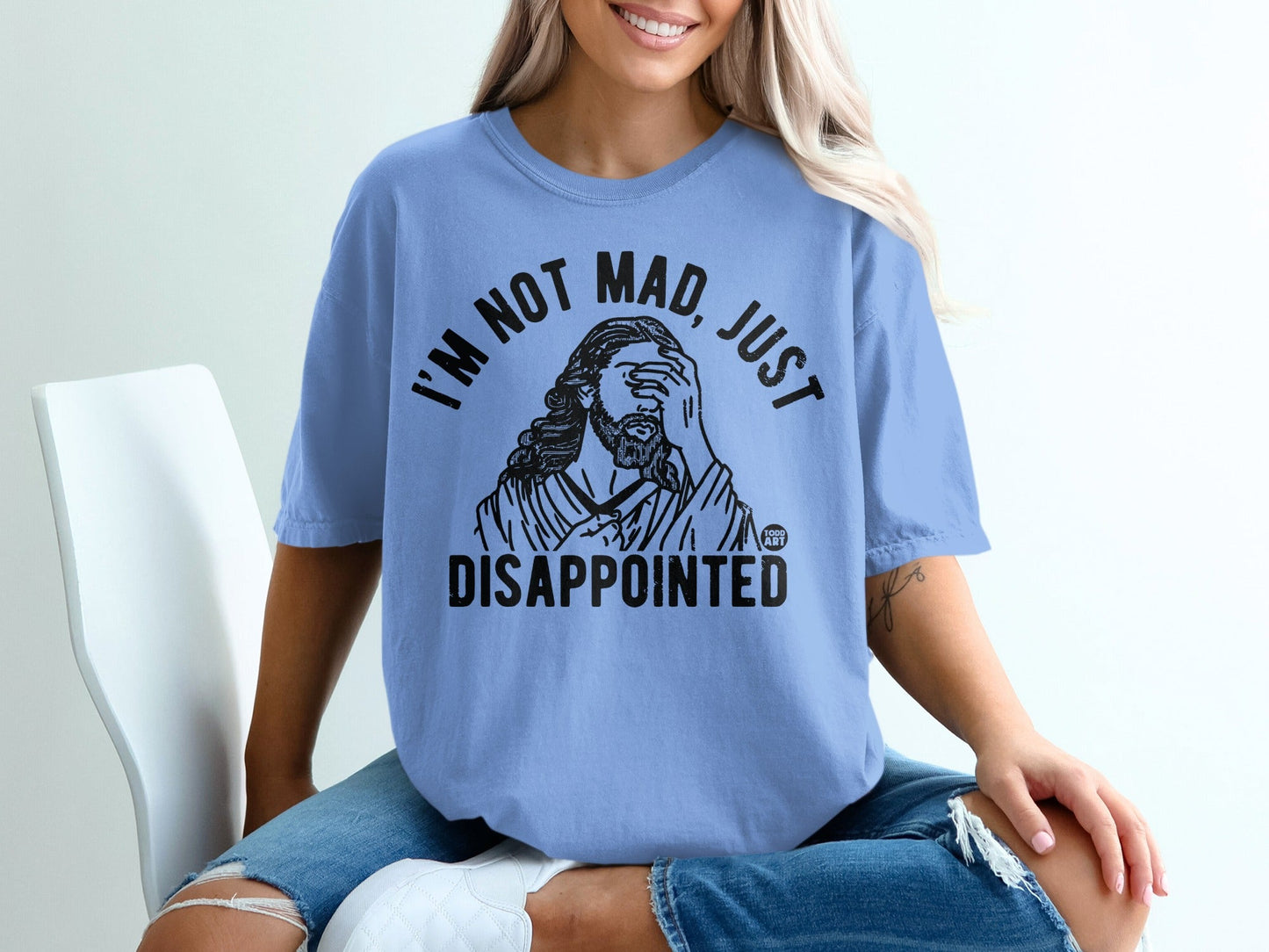 Light blue t-shirt with black text "I'M NOT MAD, JUST DISAPPOINTED" and a graphic.