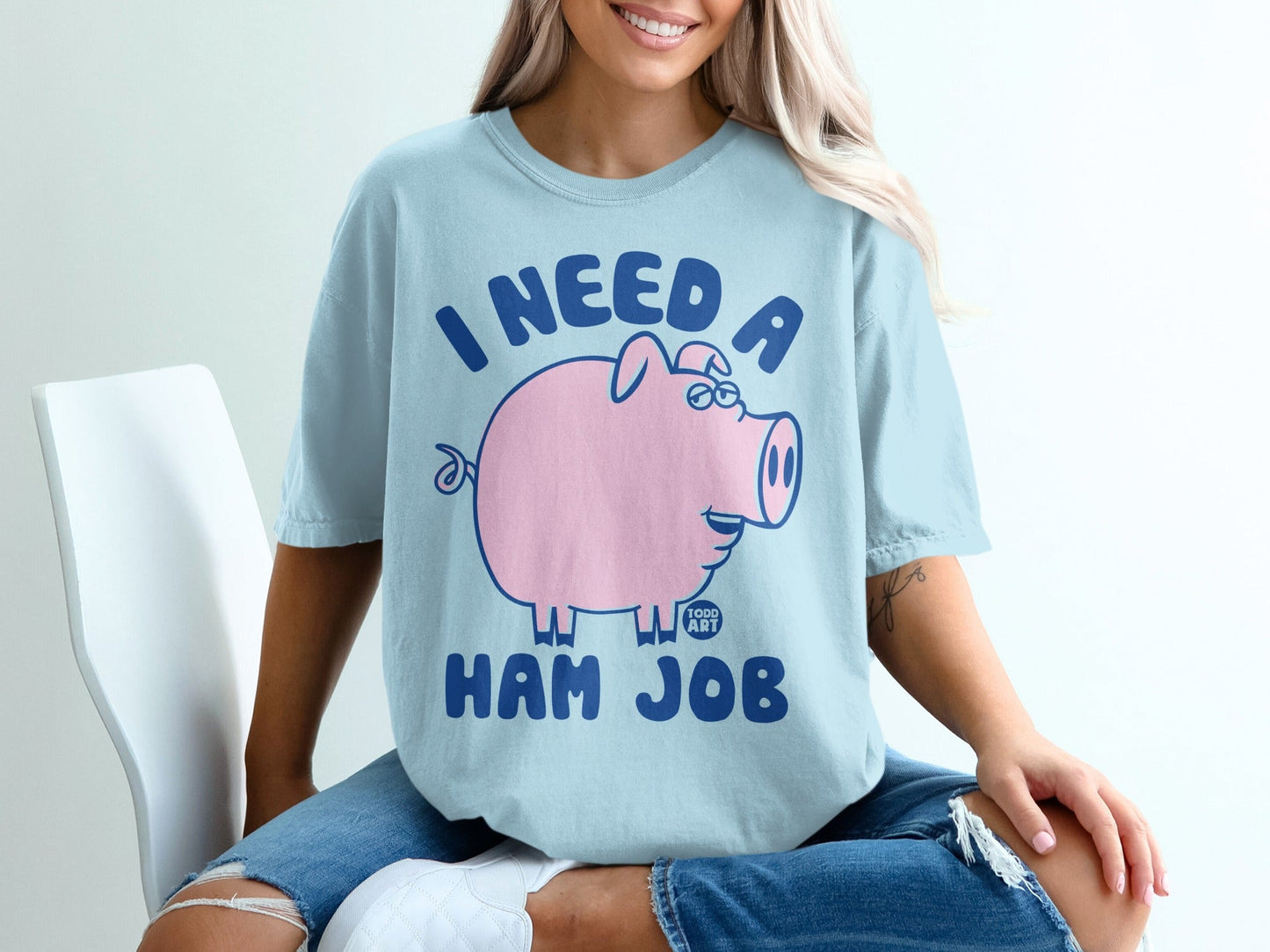 Light blue t-shirt with a pink cartoon pig and "I NEED A HAM JOB" text.