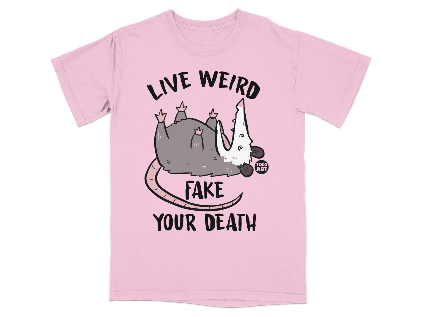 Pink t-shirt with opossum graphic and text "LIVE WEIRD FAKE YOUR DEATH".