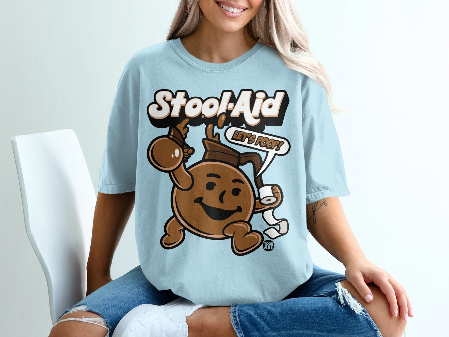 Light blue t-shirt with cartoon "Stool-Aid" character holding toilet paper.