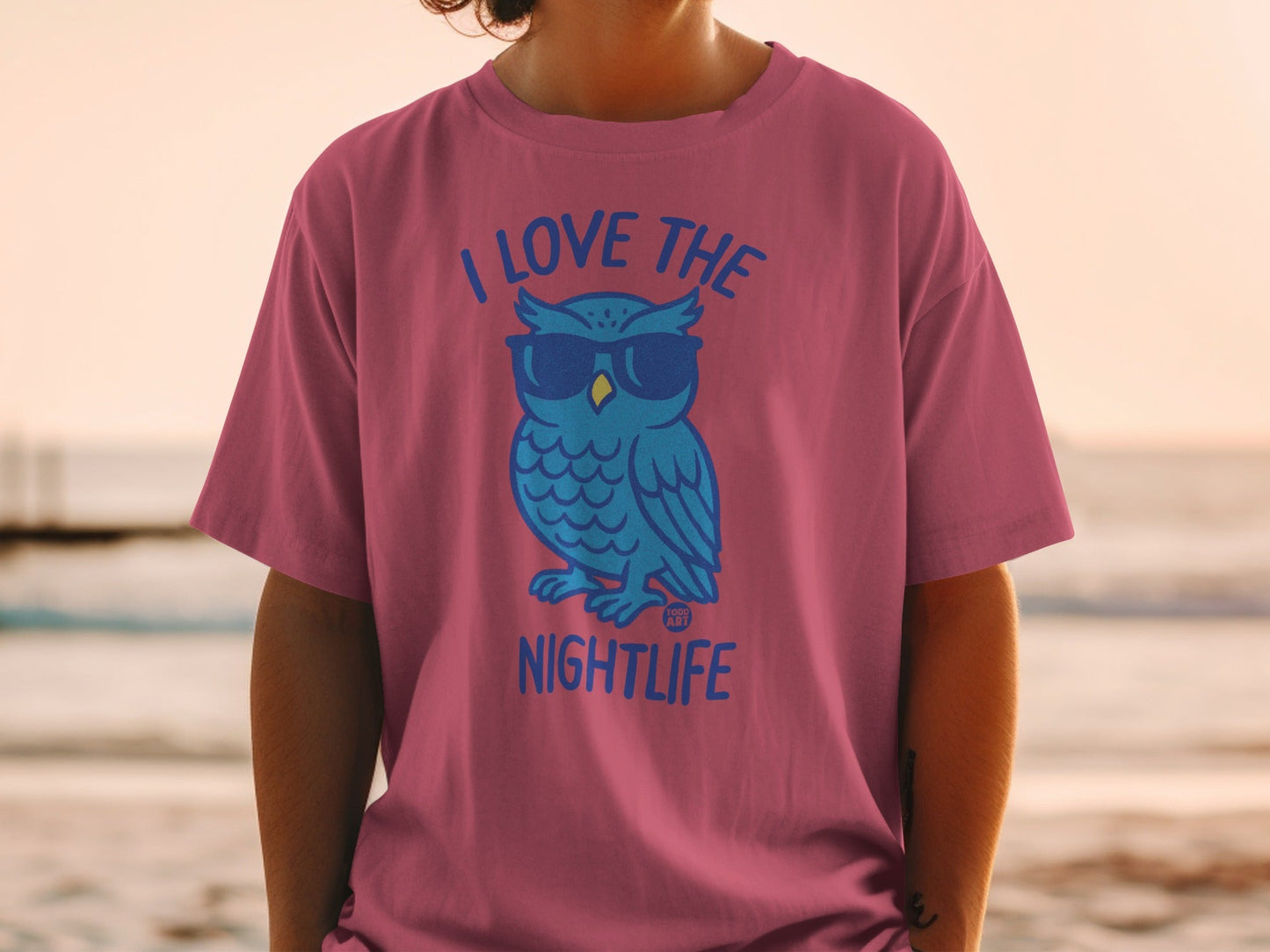 Pink t-shirt with blue cartoon owl wearing sunglasses and text "I LOVE THE NIGHTLIFE."
