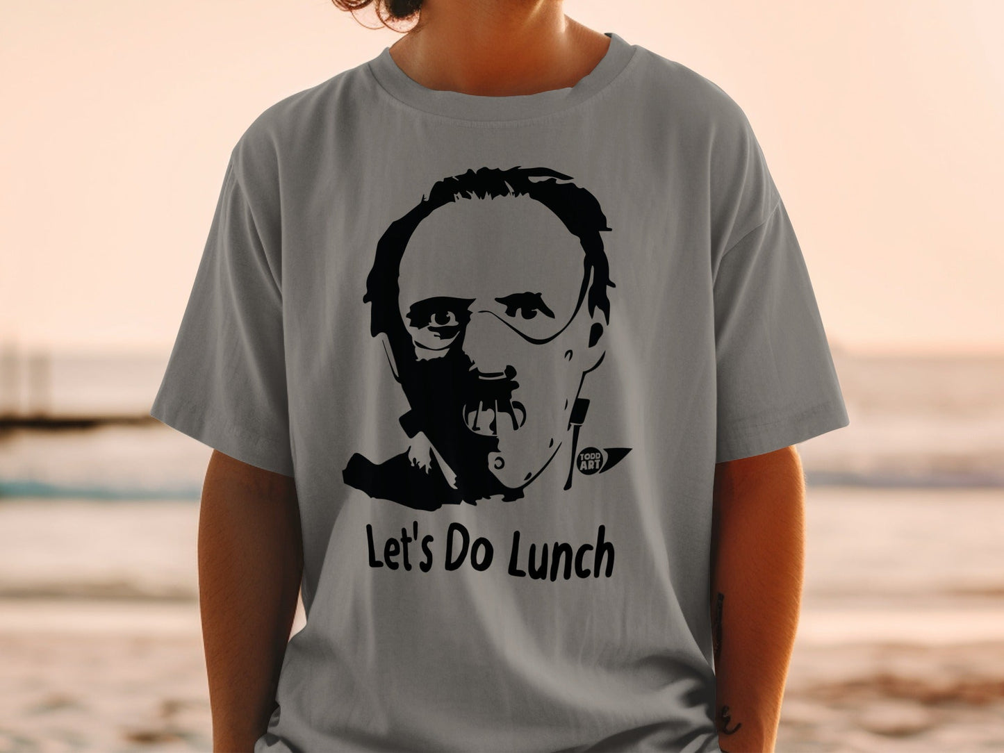 Grey t-shirt with Hannibal Lecter graphic and "Let's Do Lunch" text.