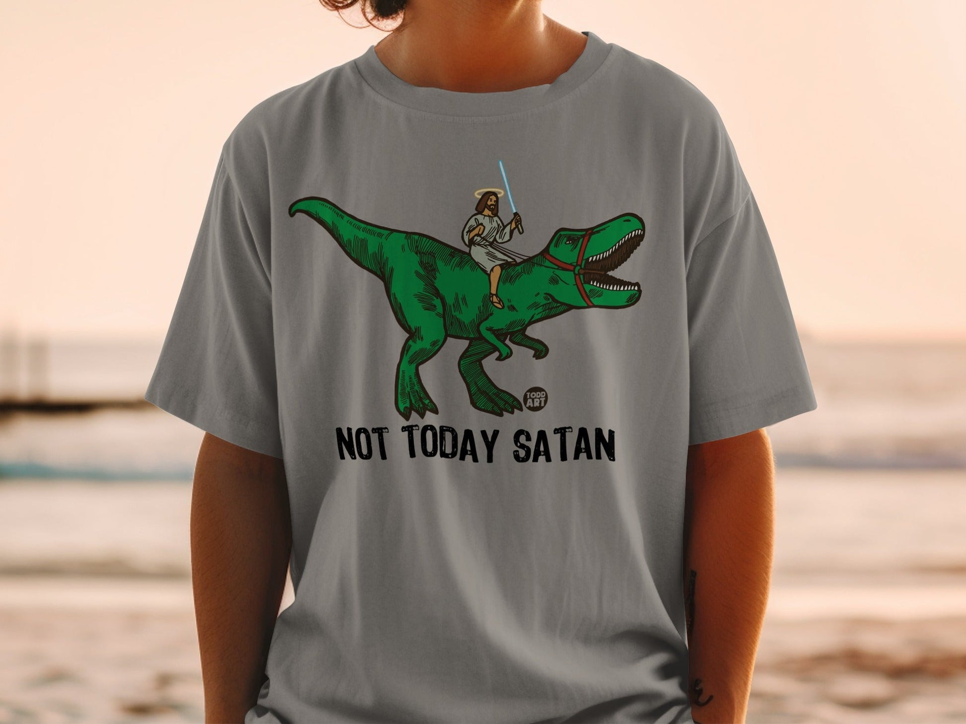 Jesus riding a T-Rex with a lightsaber, "NOT TODAY SATAN" text.