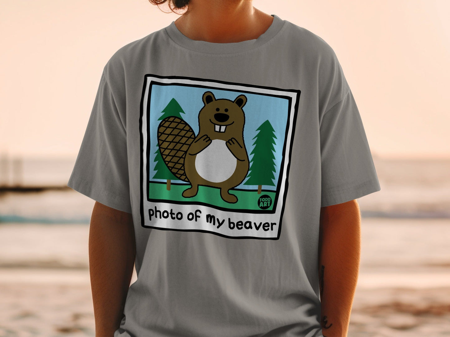 Cartoon beaver in front of trees, "photo of my beaver" text.