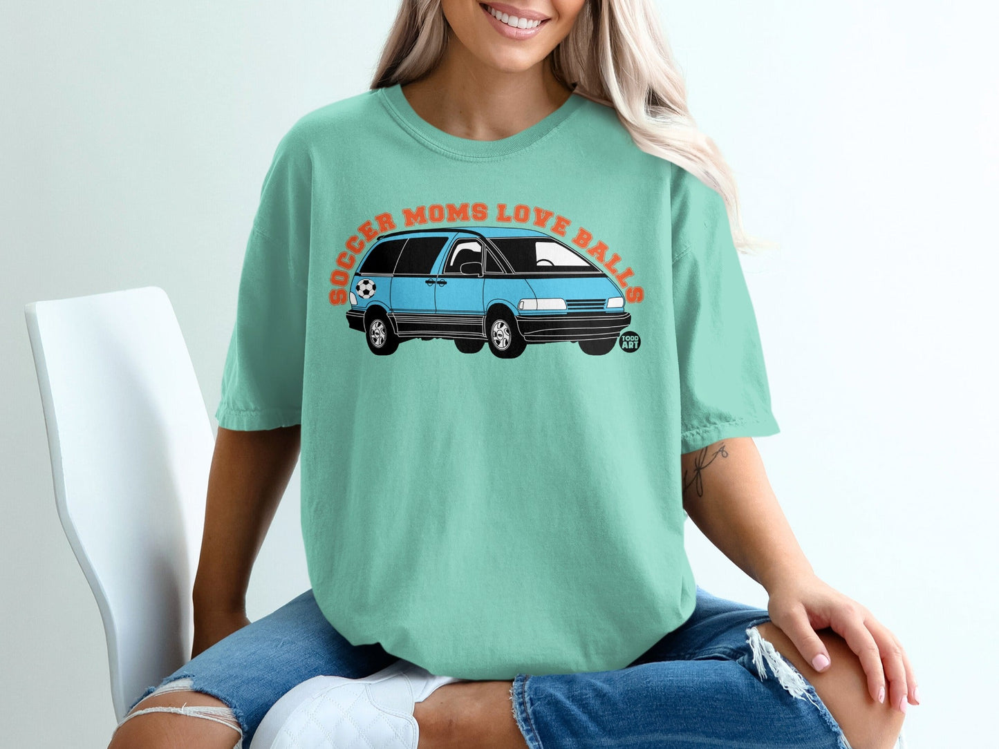 Teal t-shirt with "Soccer Moms Love Balls" text and a blue minivan illustration.
