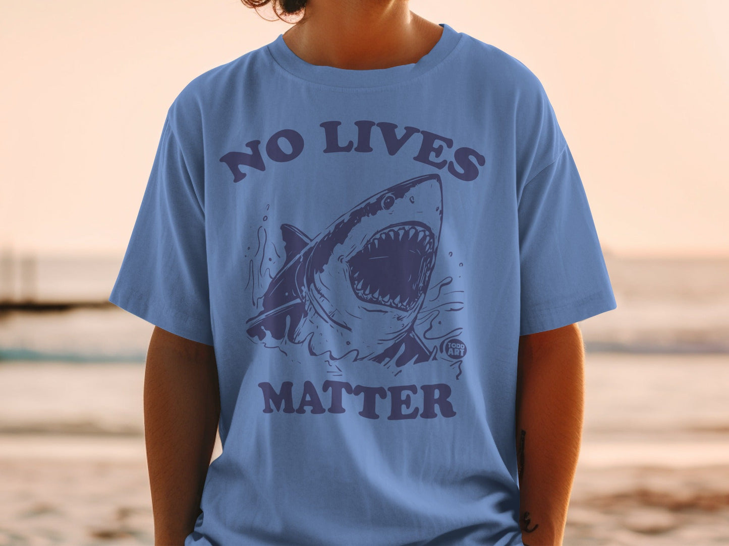 Shirt with shark graphic and text "NO LIVES MATTER".